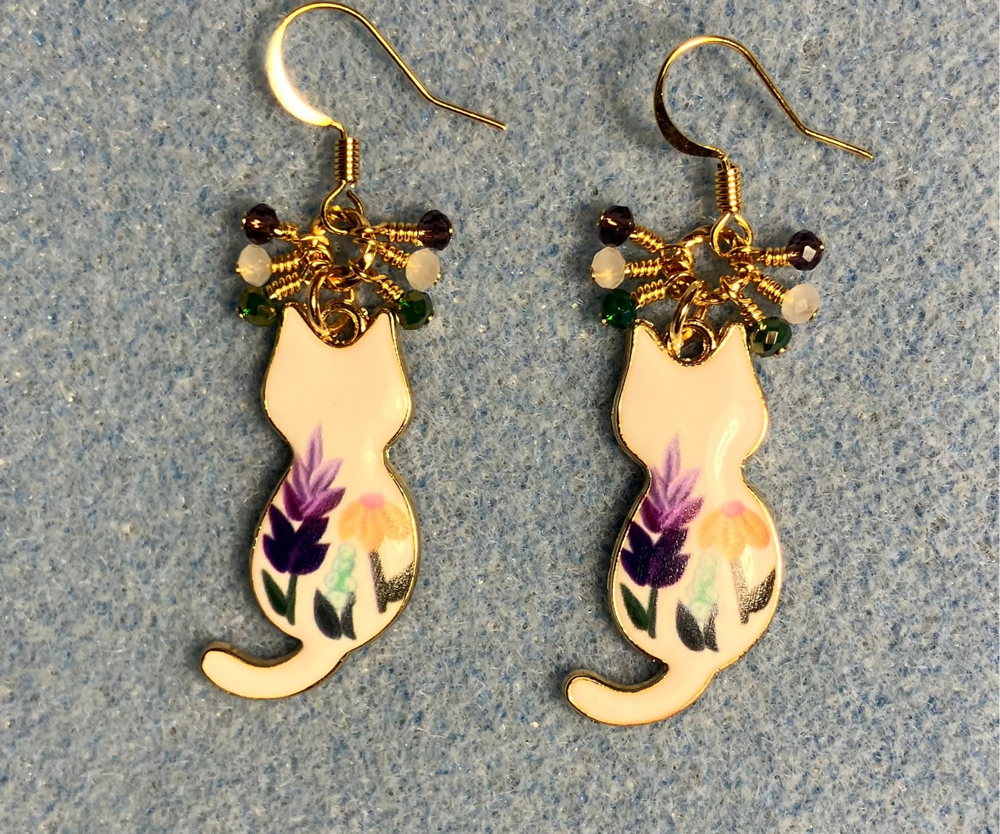 White, purple, and green enamel cat charm earrings adorned with tiny dangling white, purple, and green Chinese crystal beads.