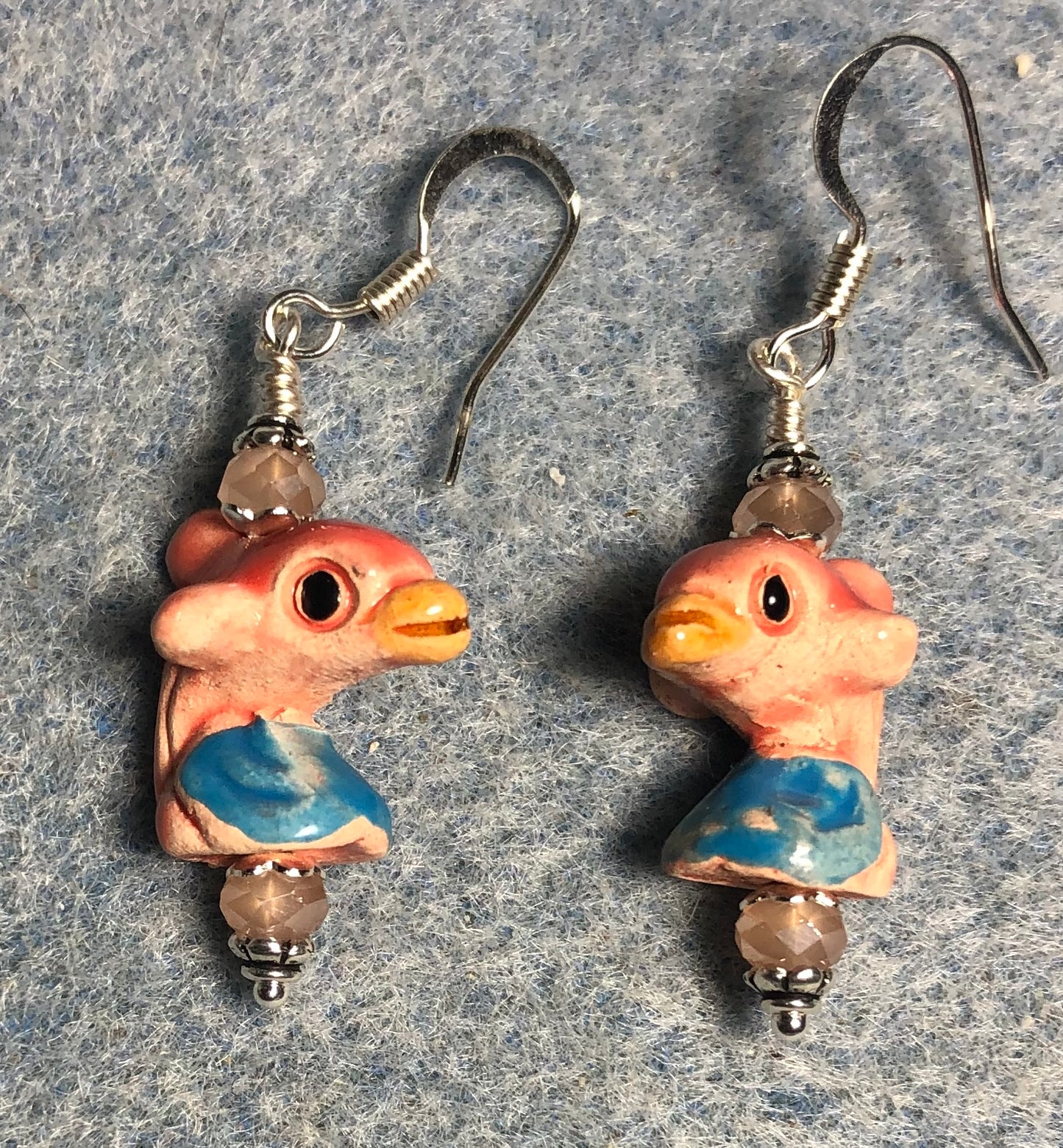 Small peach and turquoise ceramic dolphin bead earrings adorned with peach Chinese crystal beads.