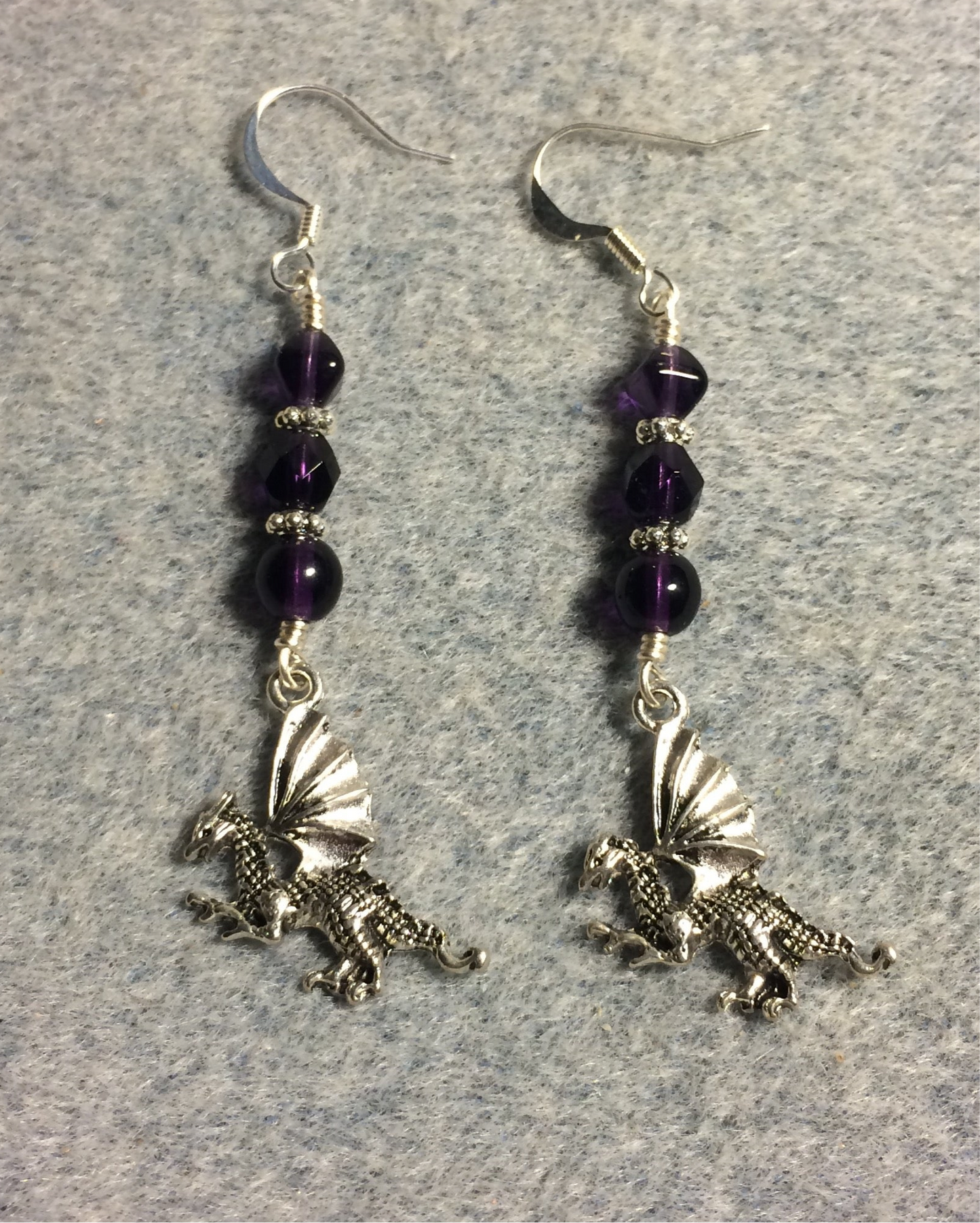 Silver dragon charm earrings adorned with grape purple Czech glass beads