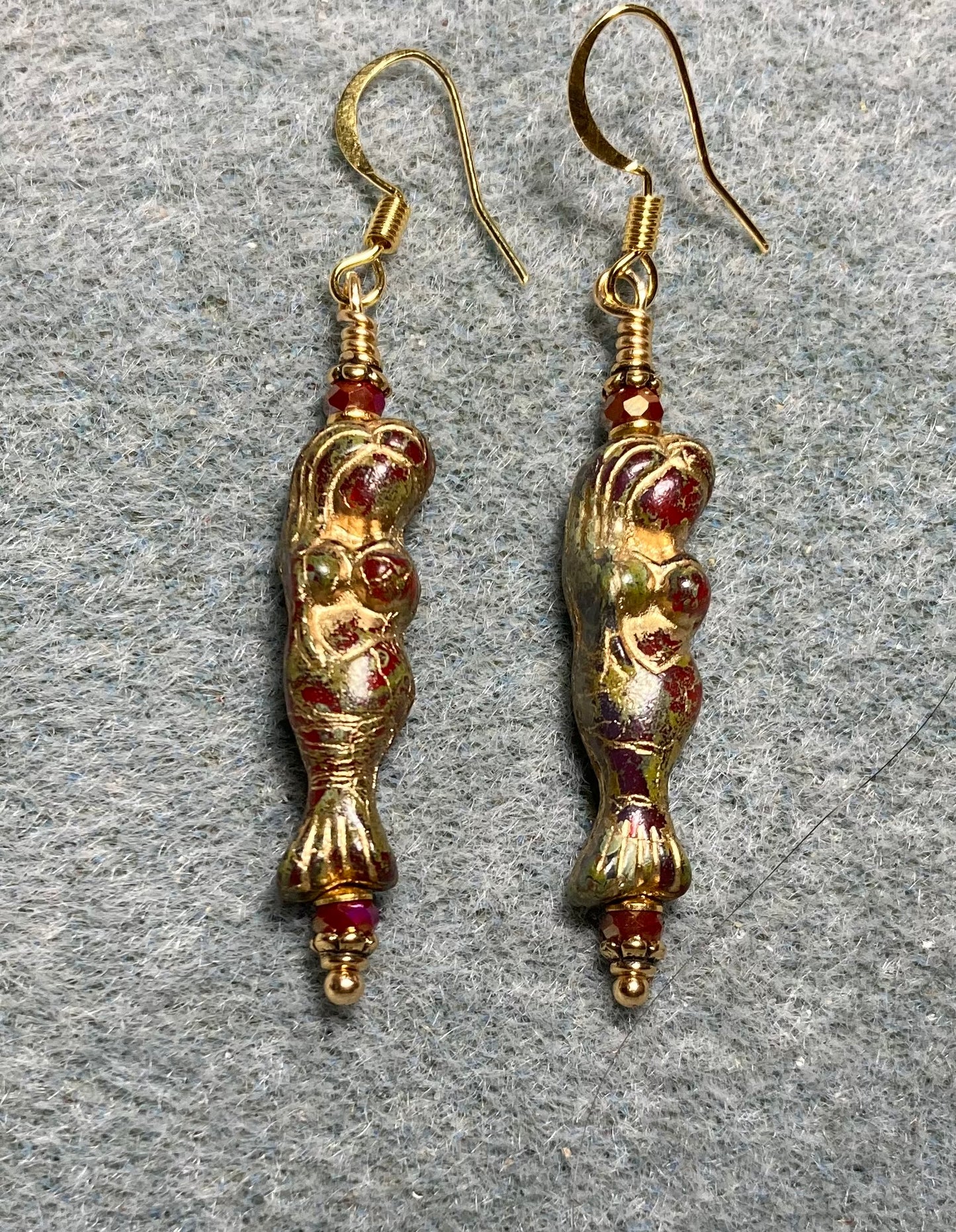 Dark red (with gold inlay) Czech glass mermaid bead earrings adorned with dark red Chinese crystal beads.
