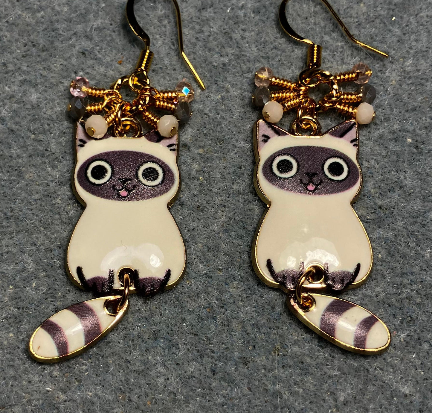 Gray and white enamel tabby cat charm earrings adorned with tiny dangling gray, pink, and white Chinese crystal beads.