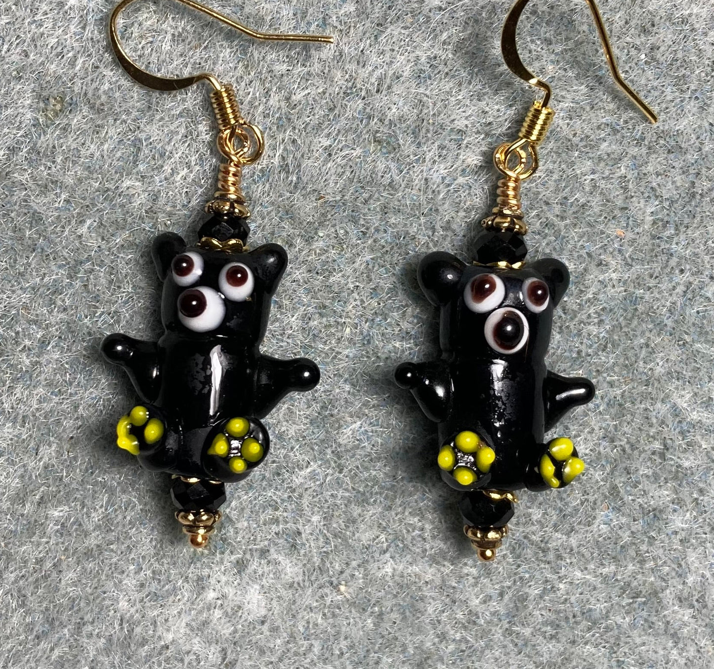 Small black and yellow lamp work teddy bear bead earrings adorned with black Chinese crystal beads.