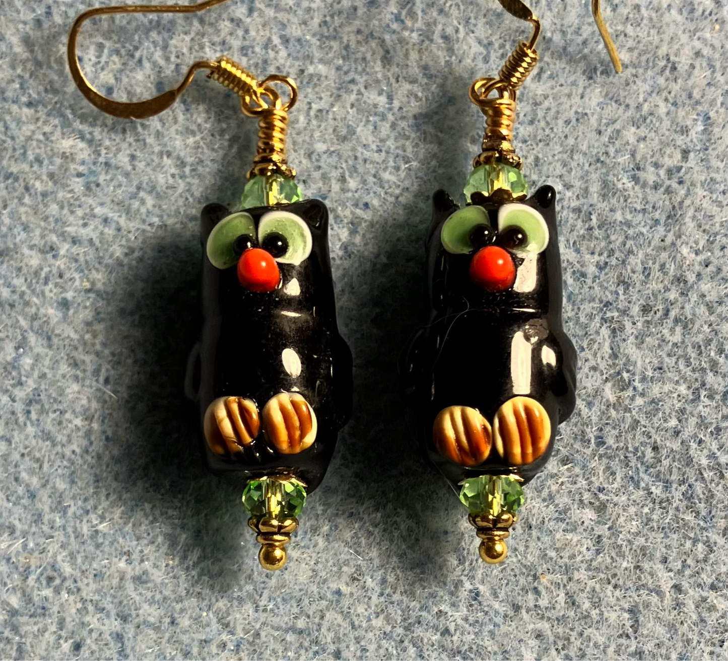 Black and green lamp work owl bead earrings adorned with green Chinese crystal beads.