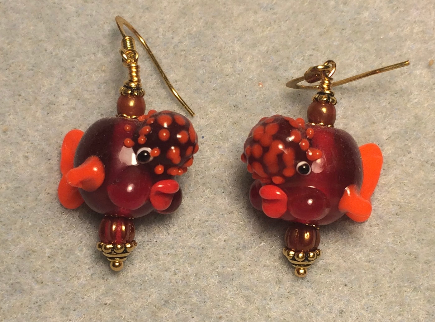 Dark red and orange lamp work clownfish bead earrings adorned with orange Czech glass beads.