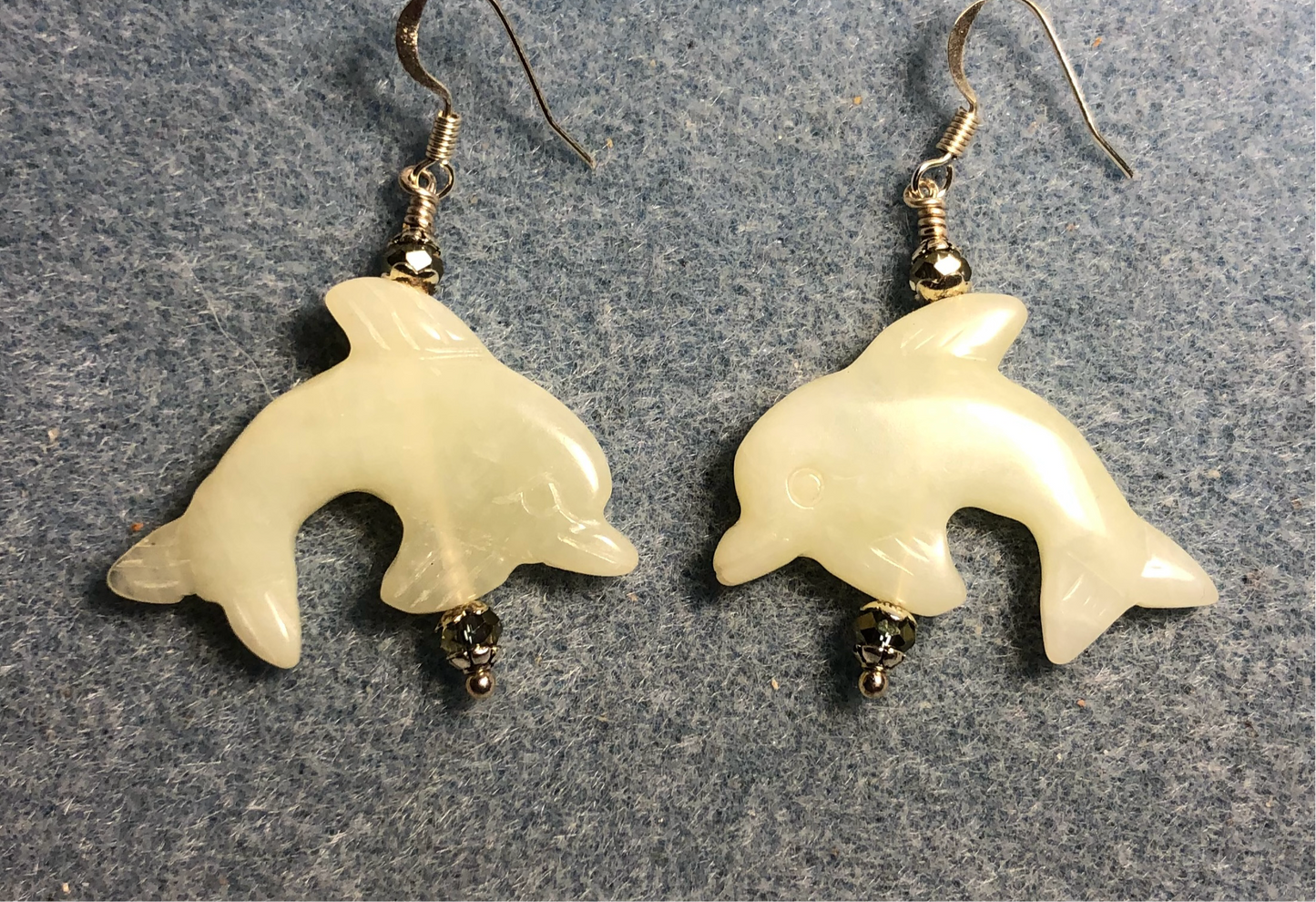 Light green new jade gemstone dolphin bead earrings adorned with sparkly green Chinese crystal beads.