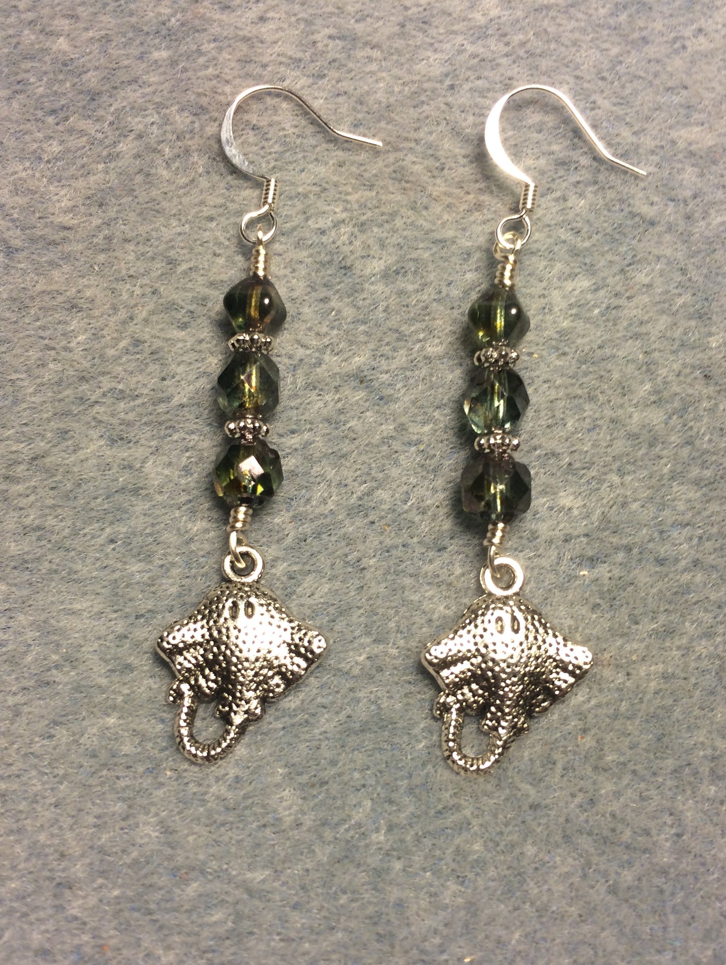 Silver stingray charm earrings adorned with green Czech glass beads