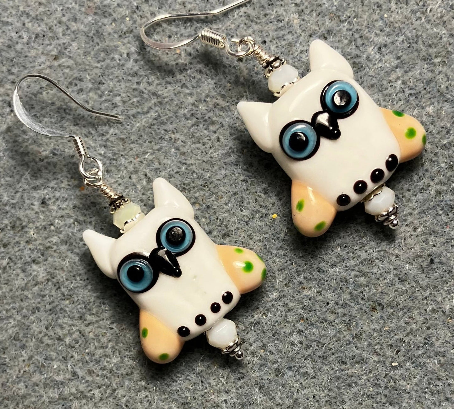 White and yellow lamp work owl bead earrings adorned with white Chinese crystal beads.