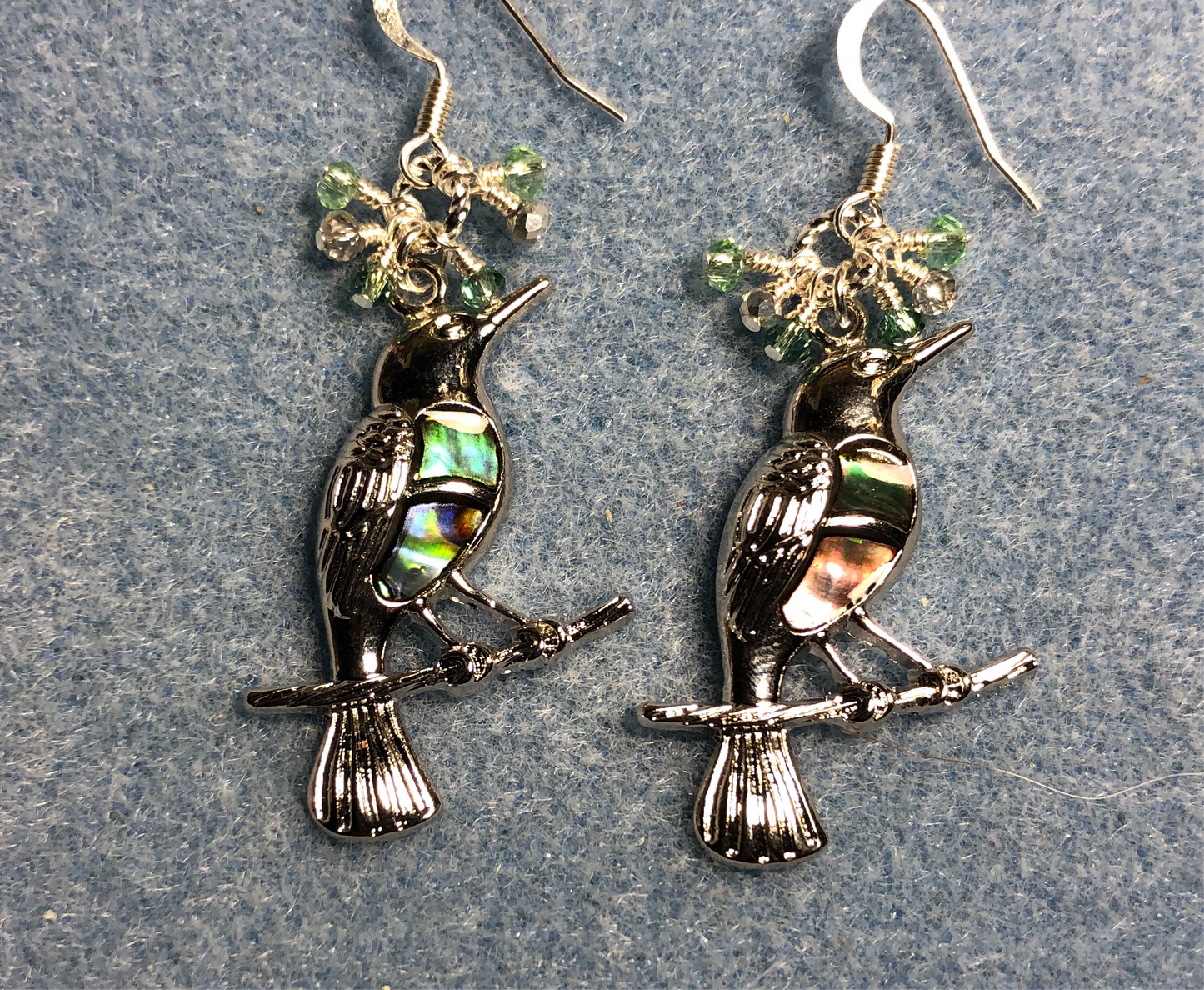 Silver and abalone bird charm earrings adorned with tiny dangling green and silver Chinese crystal beads.