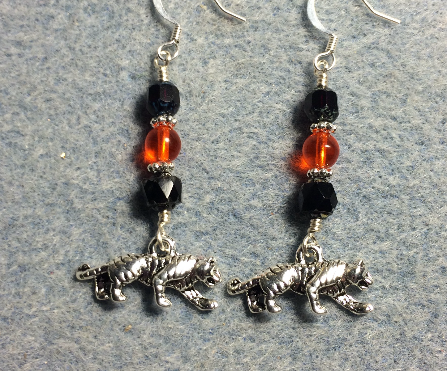 Silver tiger charm earrings adorned with black and gold Czech glass beads