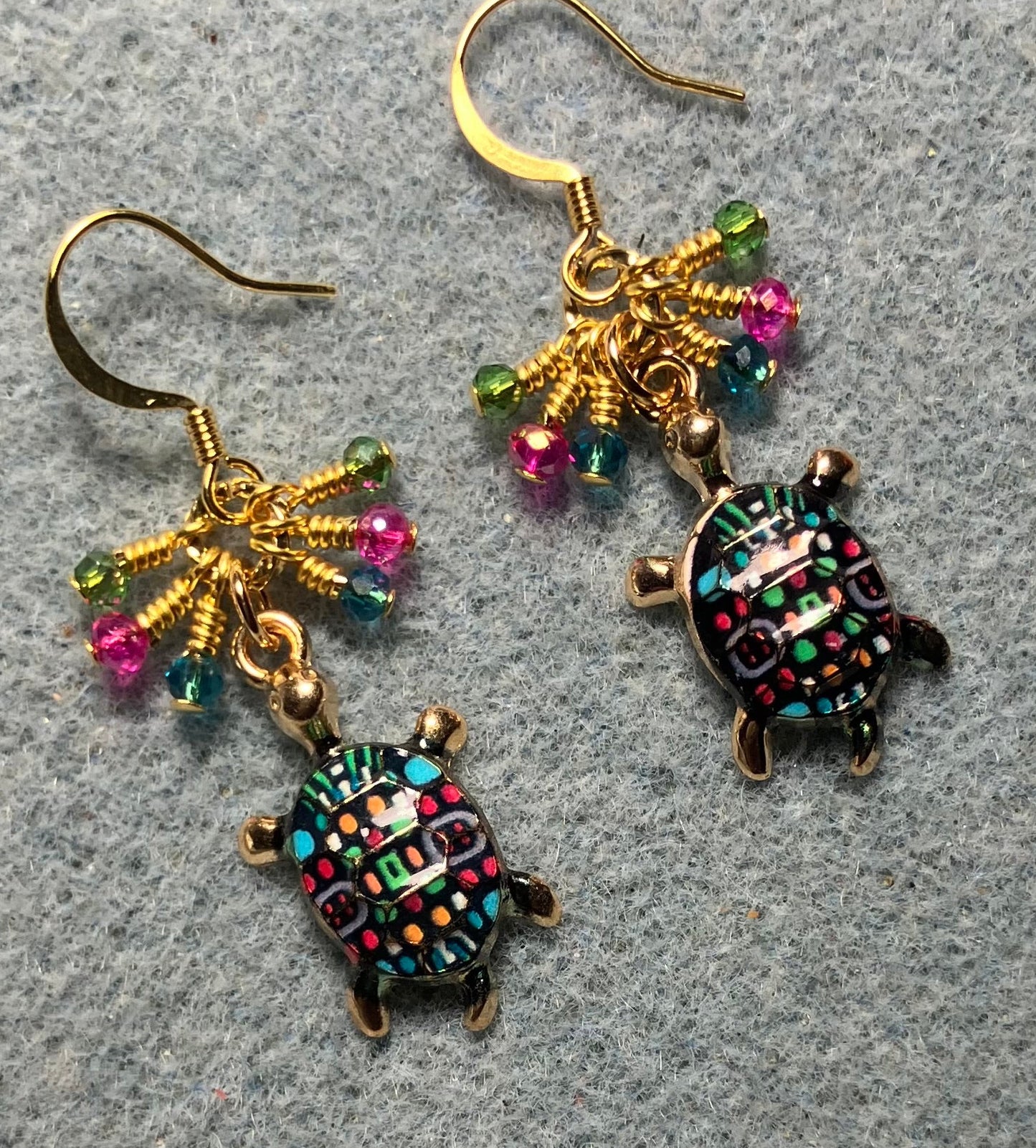 Turquoise, hot pink, and green enamel turtle charm earrings adorned with tiny dangling turquoise, hot pink, and green Chinese crystal beads.
