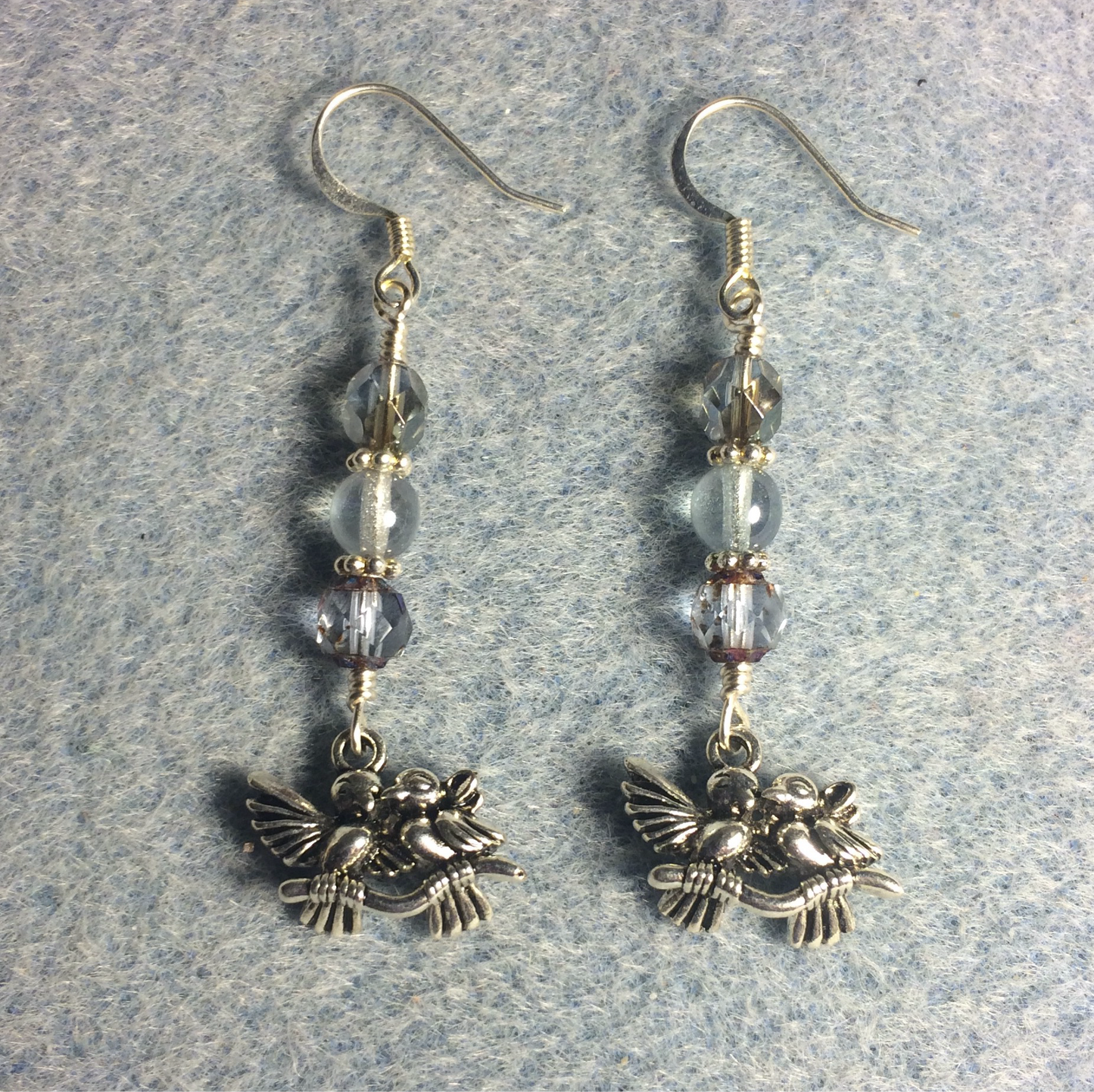 Silver lovebird charm earrings adorned with light blue Czech glass beads
