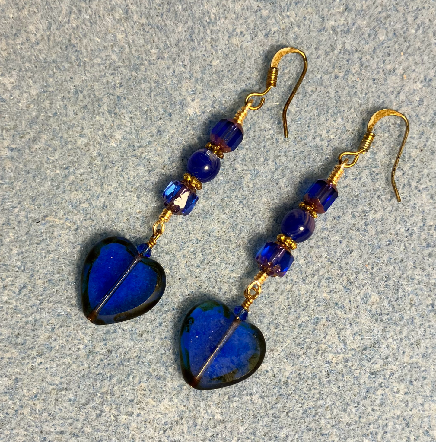 Translucent dark blue Czech glass heart bead earrings adorned with dark blue Czech glass beads.