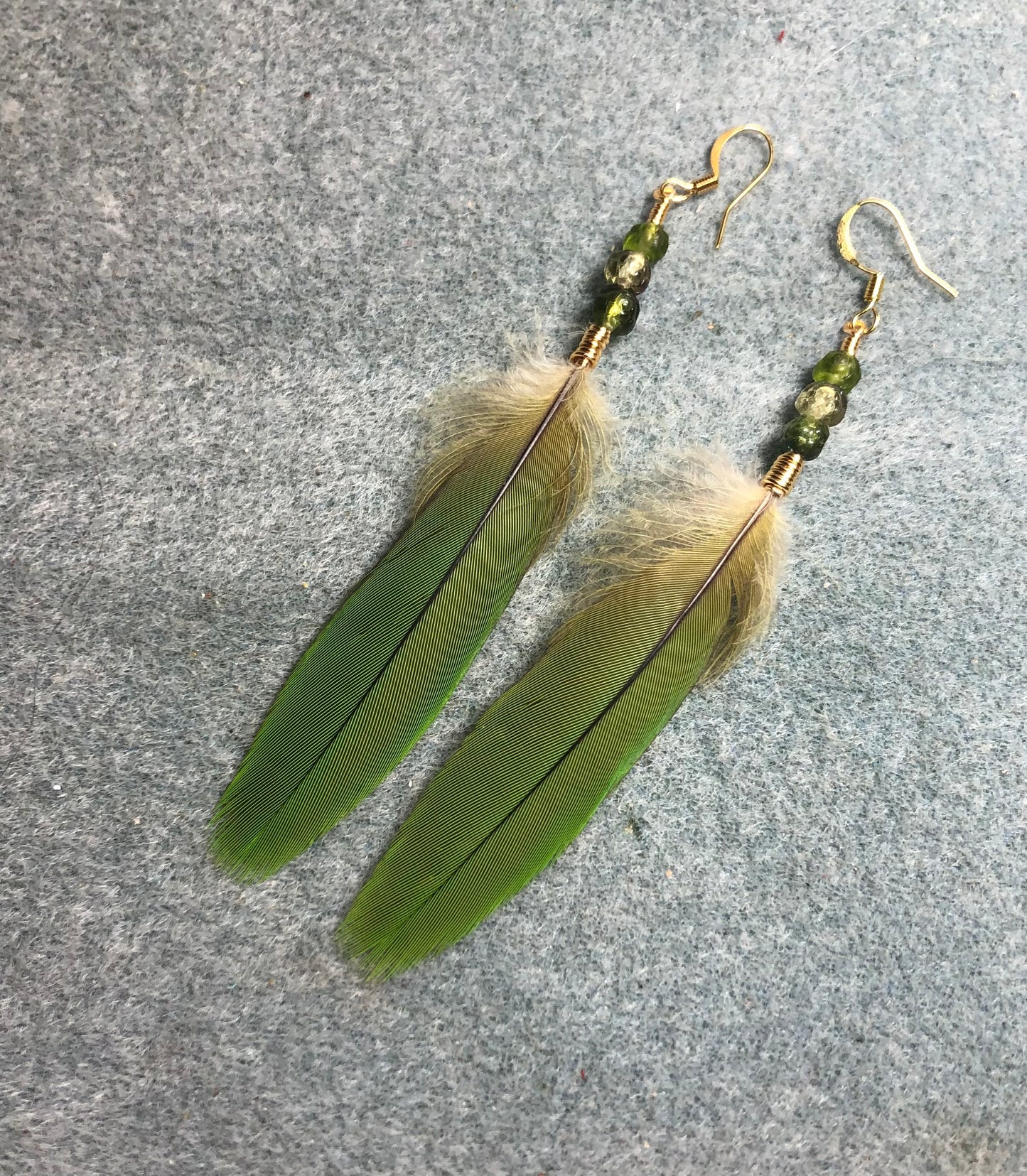 Olive green chestnut fronted mini macaw feather earrings adorned with small olive green rosebud Czech glass beads.