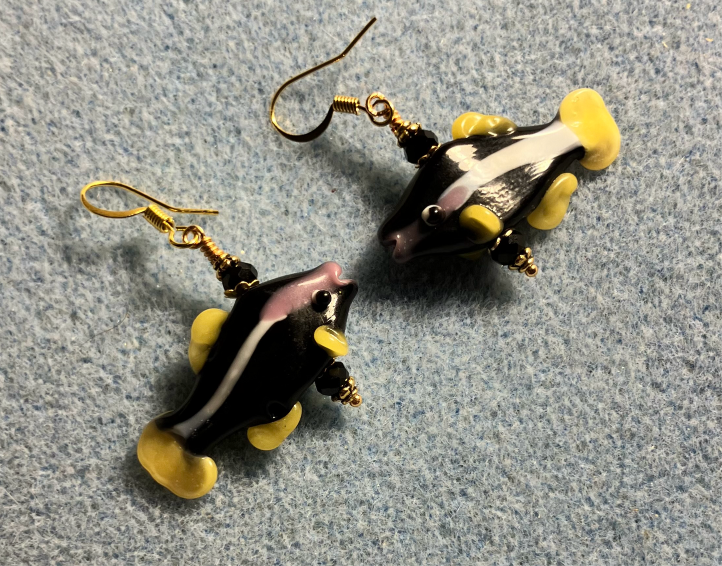 Black and yellow lamp work striped fish bead earrings adorned with black Chinese crystal beads.