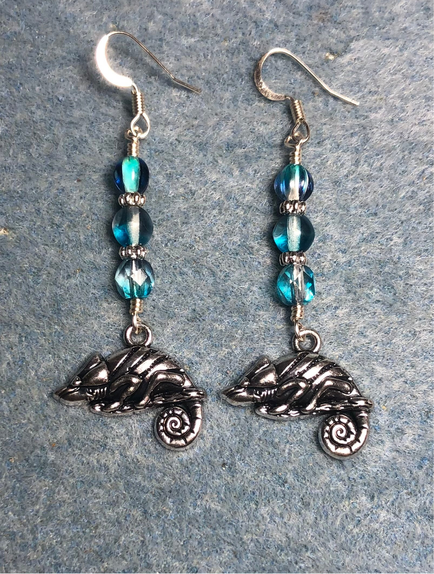 Silver chameleon charm earrings adorned with turquoise purple Czech glass beads.