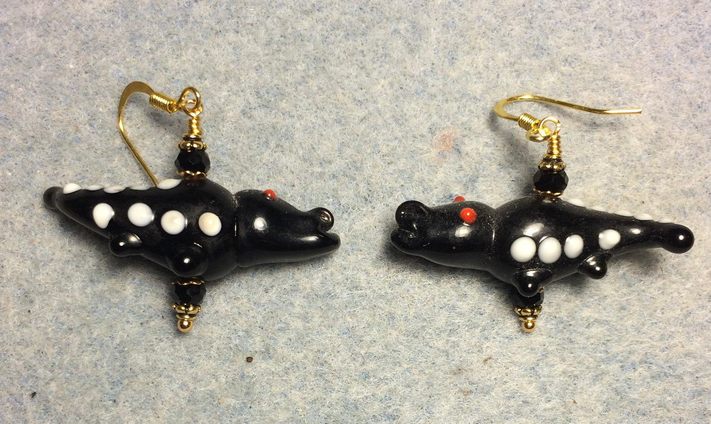 Opaque black lamp work spotted alligator bead earrings adorned with black Chinese crystal beads.