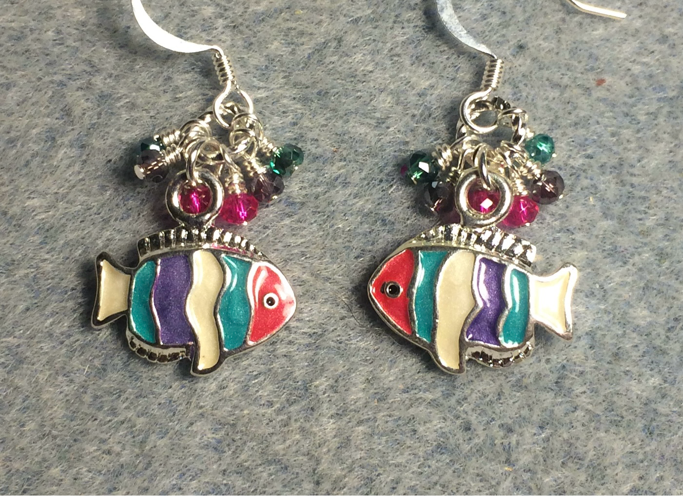 Turquoise, purple, and pink enamel striped fish charm earrings adorned with tiny dangling turquoise, purple, and pink Chinese crystal beads.