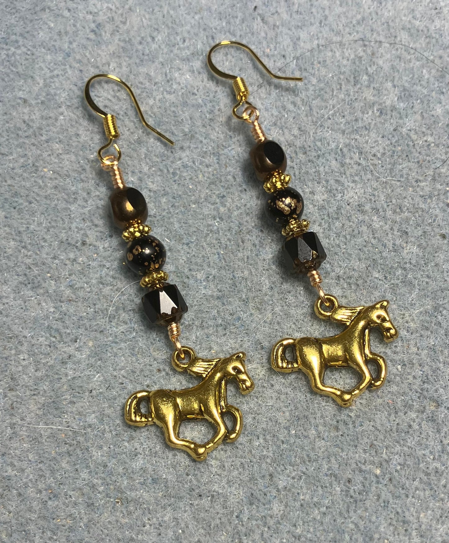 Gold horse charm earrings adorned with black Czech glass beads
