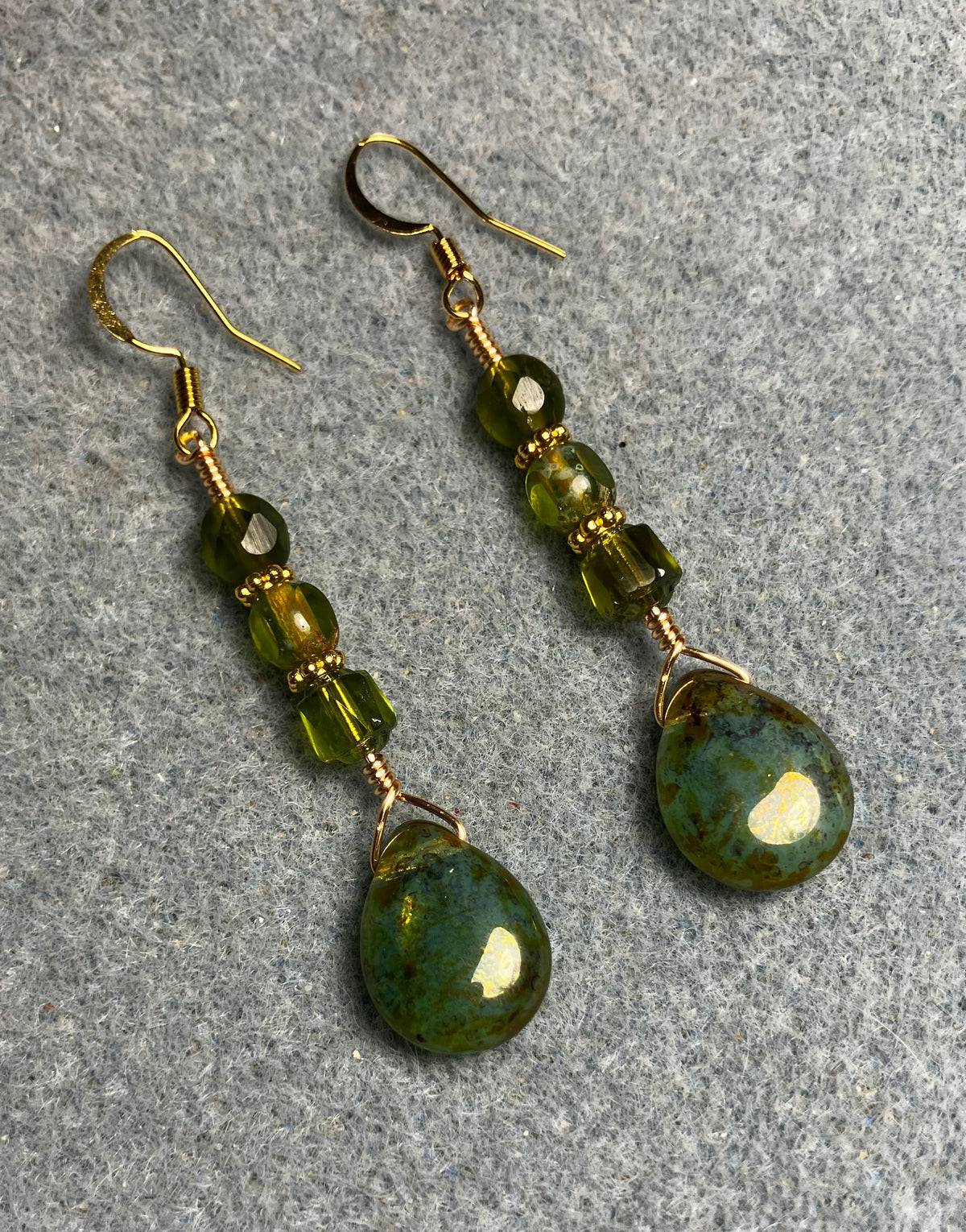 Olive green Czech glass pear drop bead earrings adorned with olive green Czech glass beads.