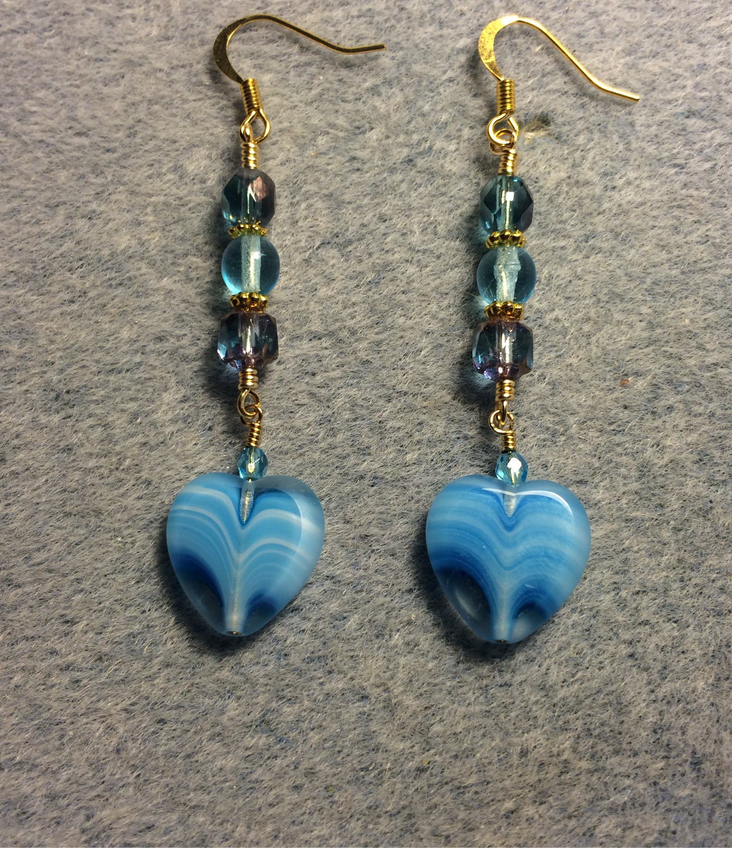 Turquoise Czech glass heart bead earrings adorned with turquoise Czech glass beads.
