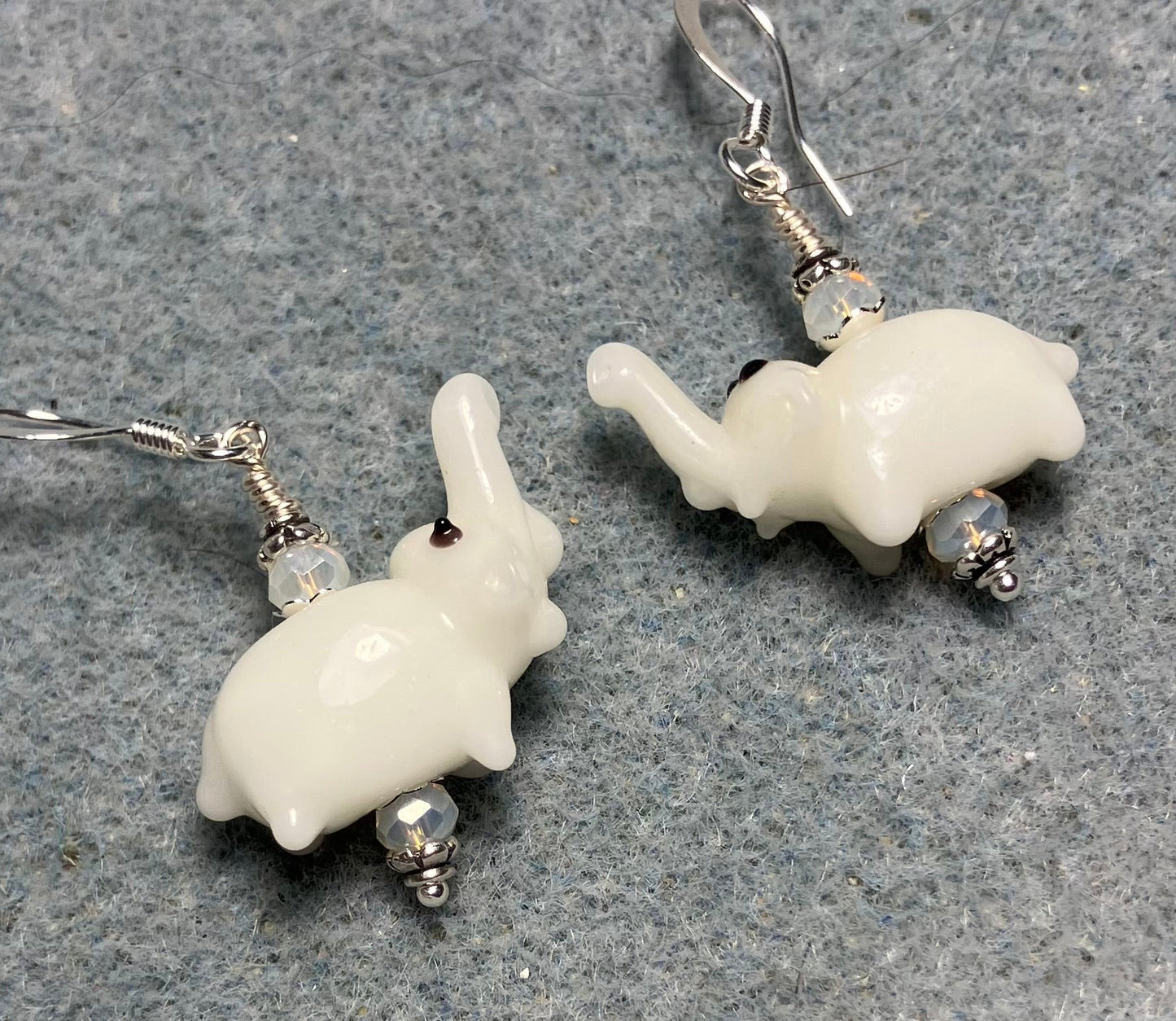 Small white lamp work elephant bead earrings adorned with white Chinese crystal beads.