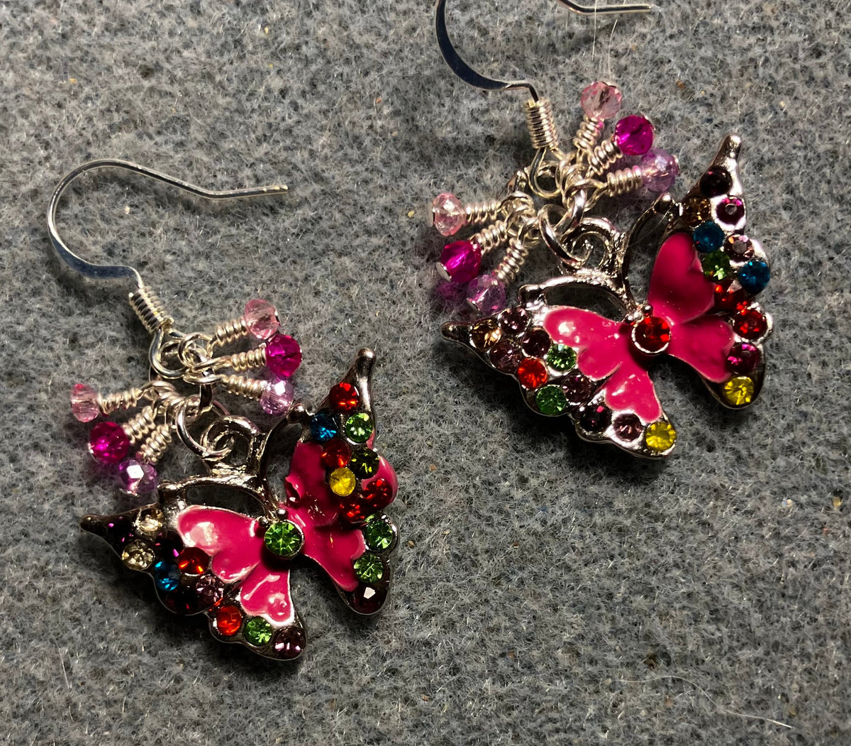 Hot pink enamel and colored rhinestone butterfly charm earrings adorned with tiny dangling hot pink and light pink Chinese crystal beads.