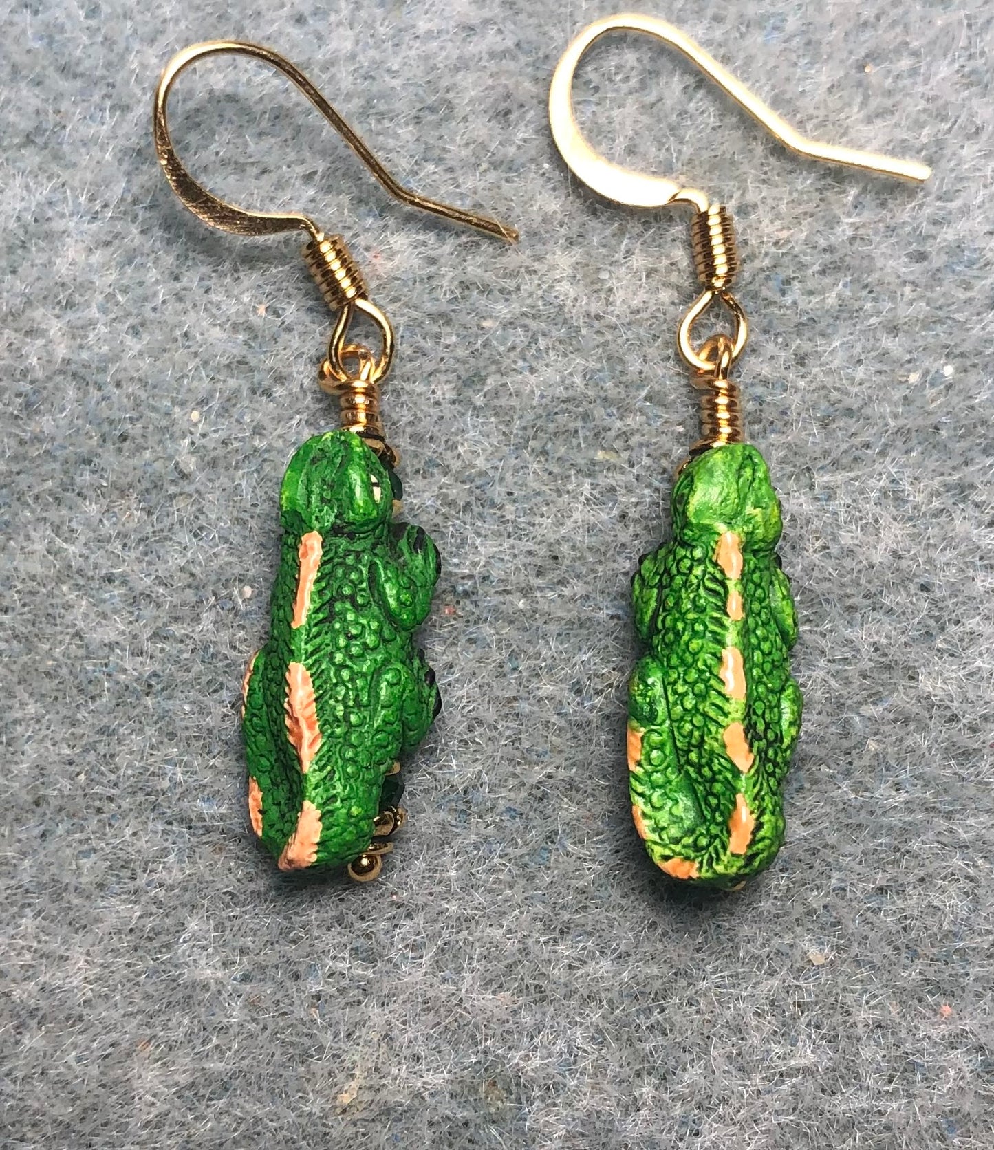 Small green and tan ceramic iguana bead earrings adorned with green Chinese crystal beads.