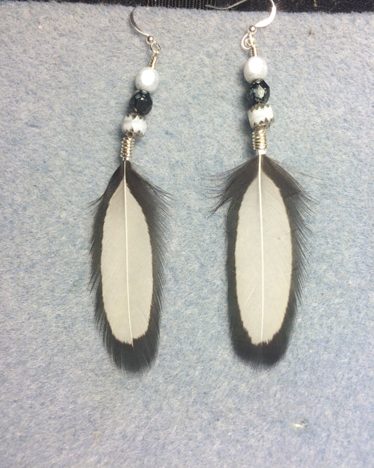 White and black chicken feather earrings adorned with white and black Czech glass beads.