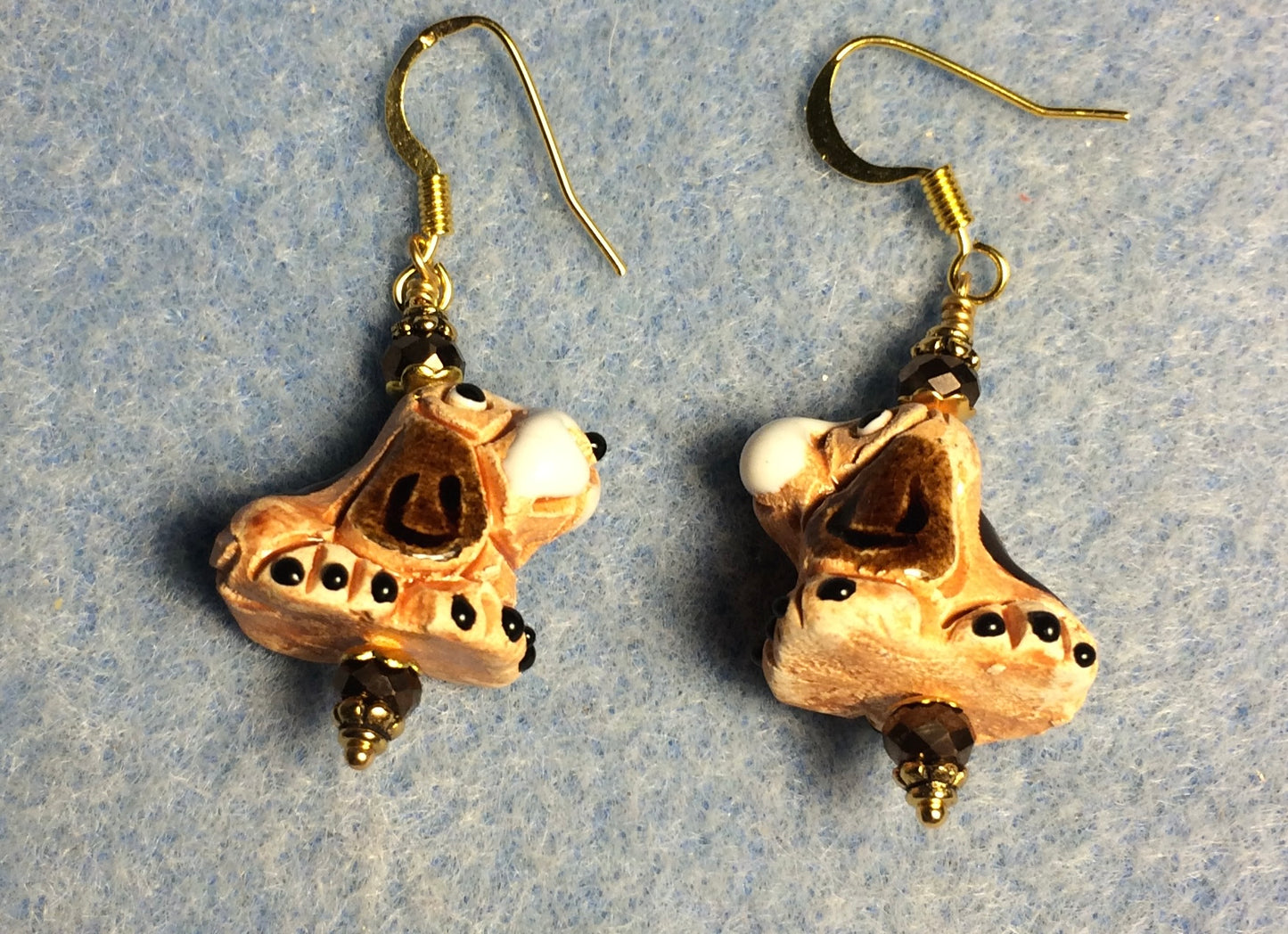 Small tan, brown, and white ceramic hound dog bead earrings adorned with brown Chinese crystal beads.