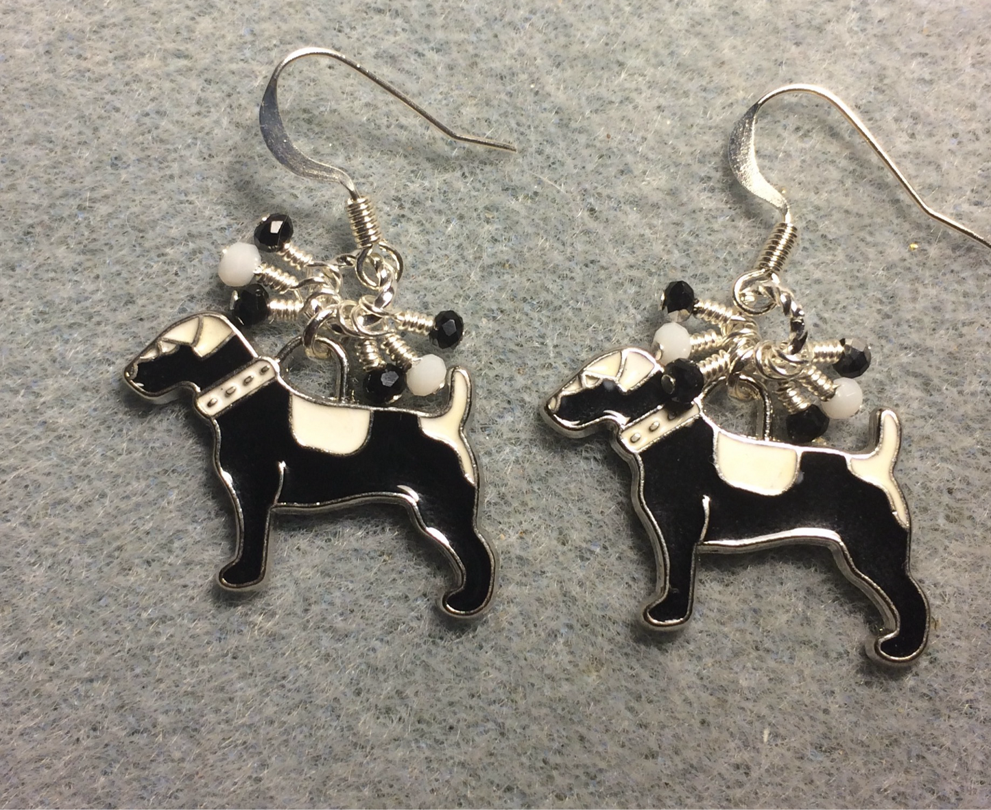 Black and white enamel hound dog charm earrings adorned with tiny dangling black and white Chinese crystal beads.