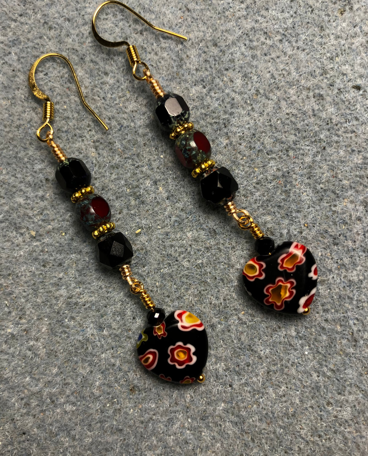 Small black and dark red millefiori Czech glass heart bead earrings adorned with black and dark red Czech glass beads.