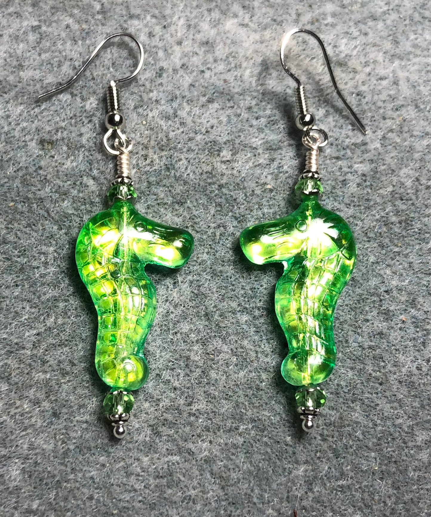 Shimmery green Czech glass seahorse bead earrings adorned with green Chinese crystal beads.