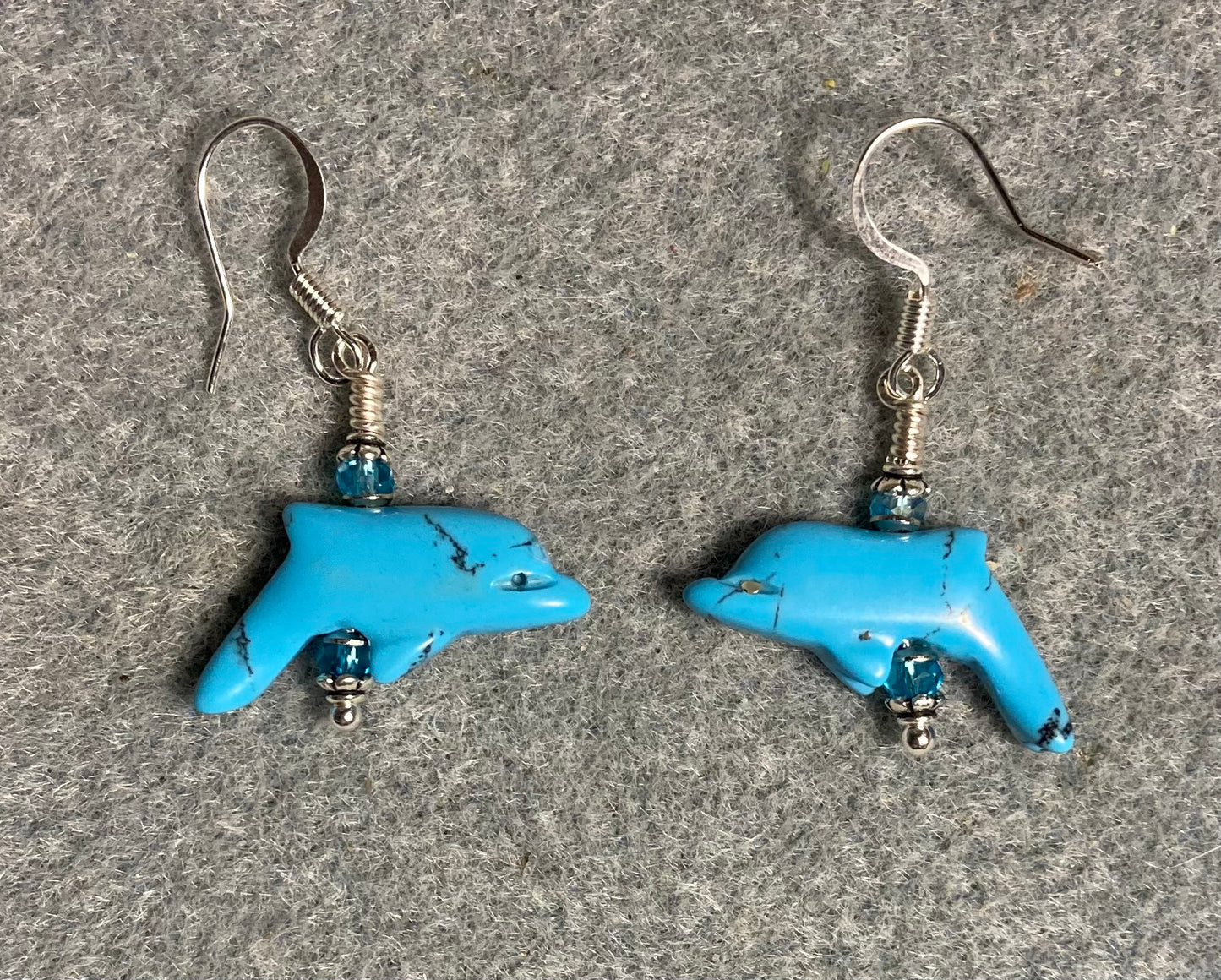 Turquoise howlite gemstone dolphin bead earrings adorned with turquoise Chinese crystal beads.