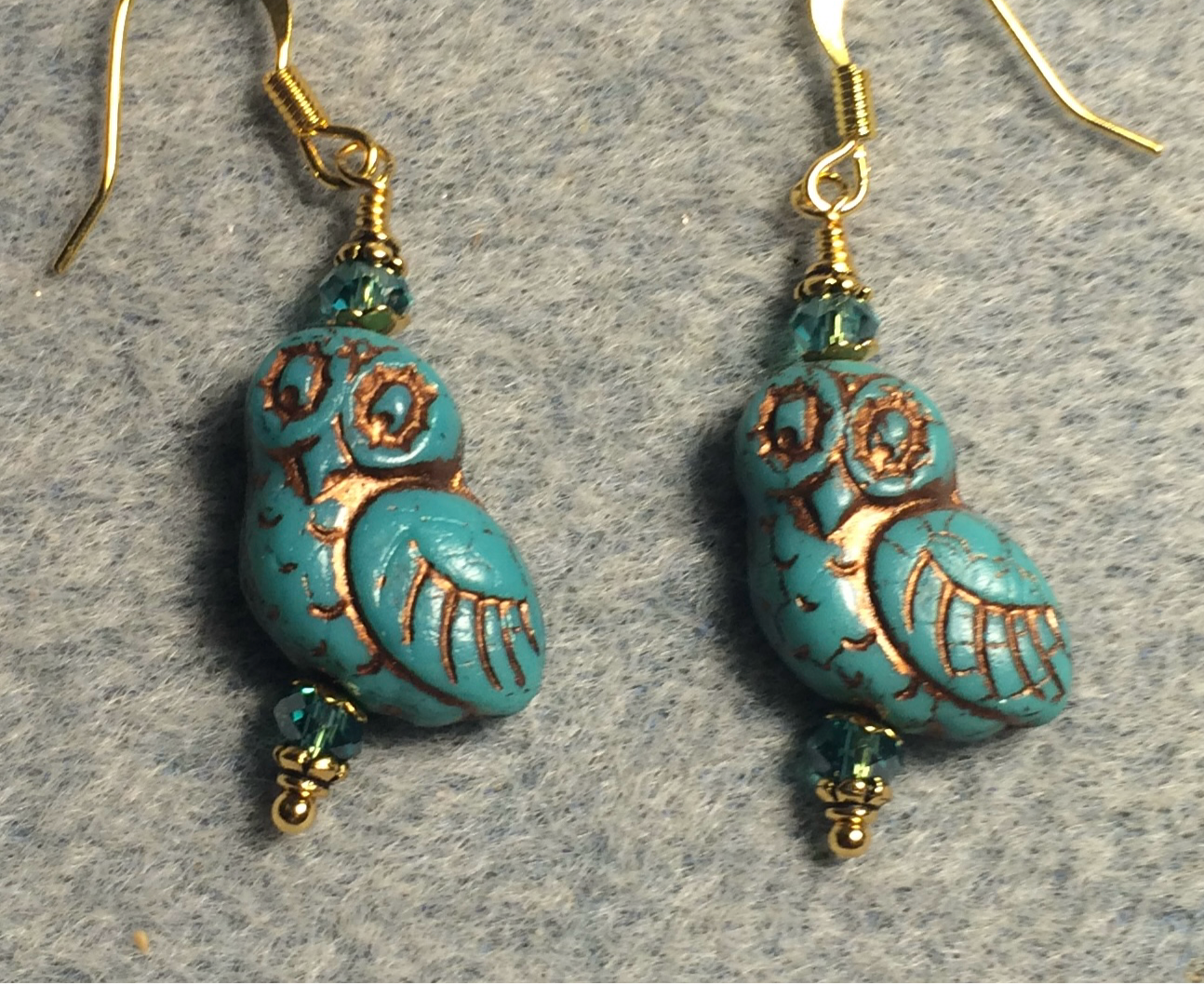 Teal turquoise (with copper wash) fancy Czech glass owl bead earrings adorned with teal Chinese crystal beads.
