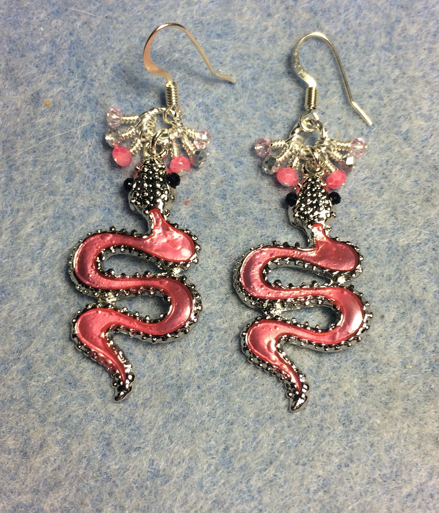 Pink enamel coiled snake charm earrings adorned with tiny dangling pink and silver Chinese crystal beads.