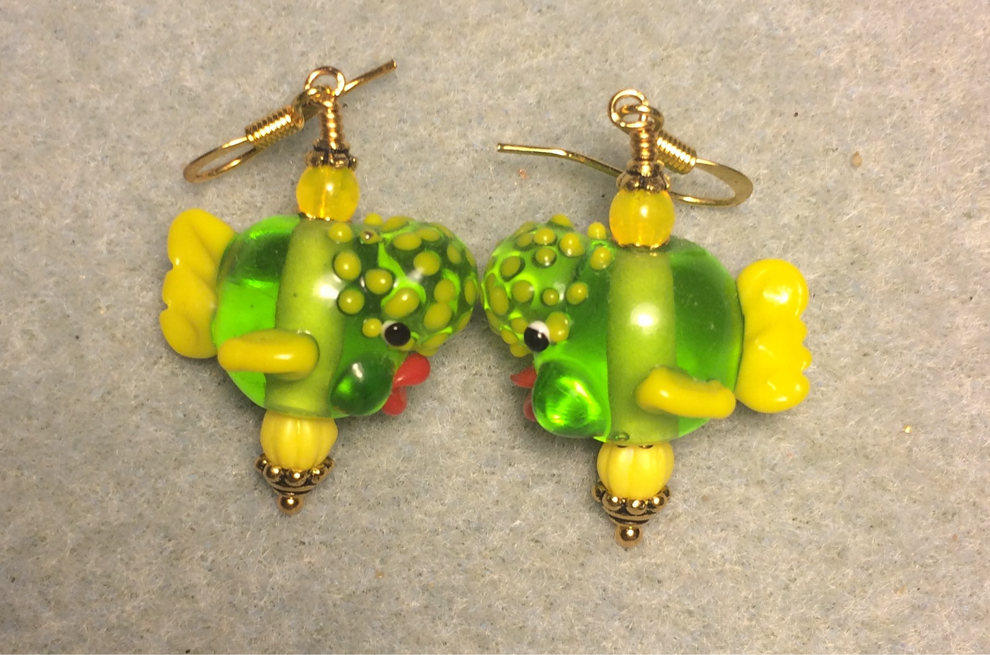 Translucent lime green and yellow lamp work clownfish bead earrings adorned with yellow Czech glass beads.