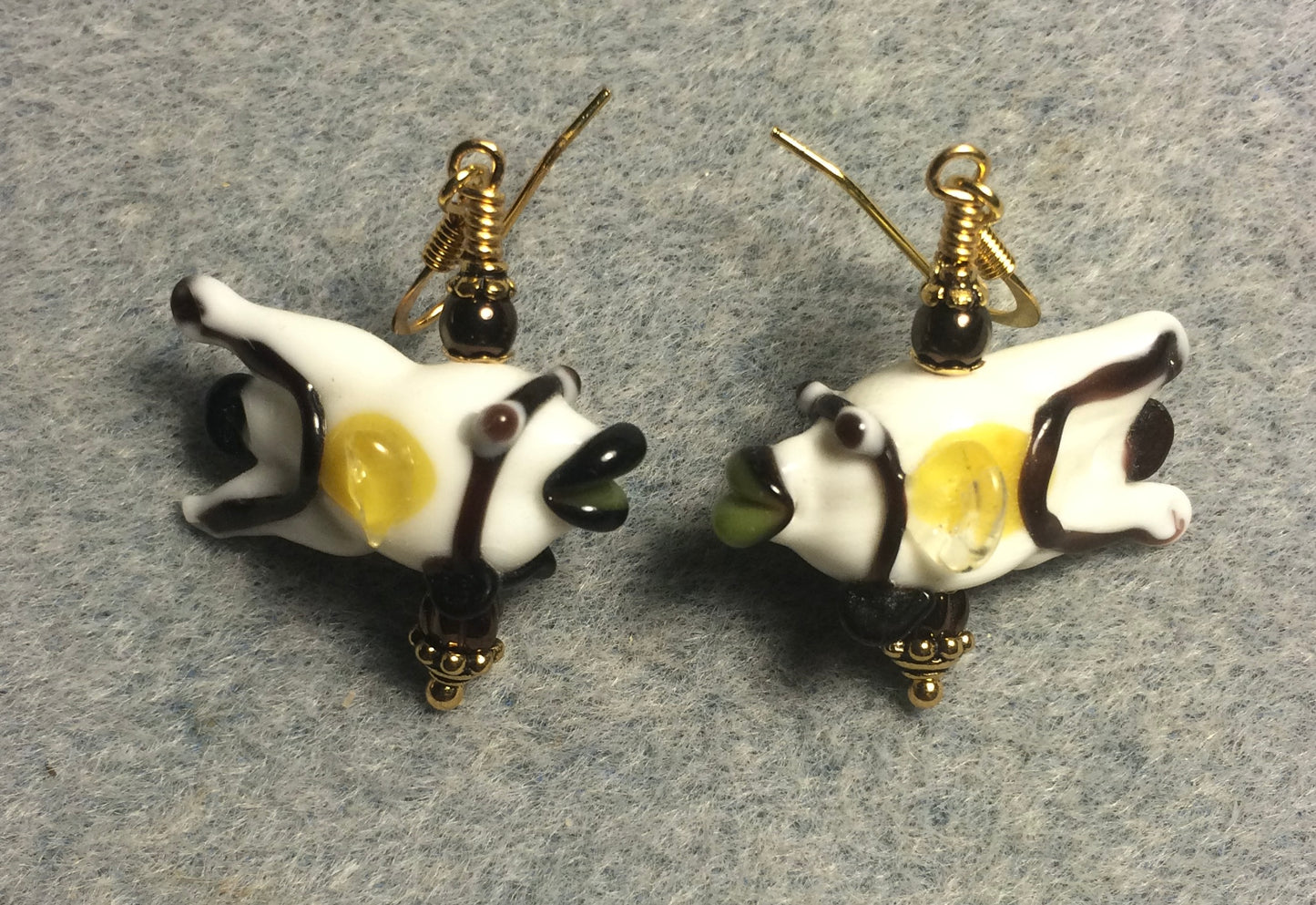 White, brown, and yellow lamp work kissing fish bead earrings adorned with brown Czech glass beads.