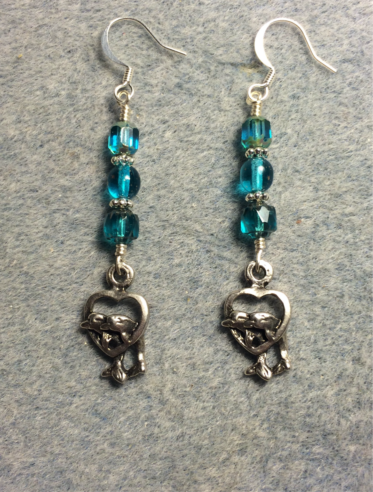 Silver dolphins in a heart charm earrings adorned with turquoise Czech glass beads