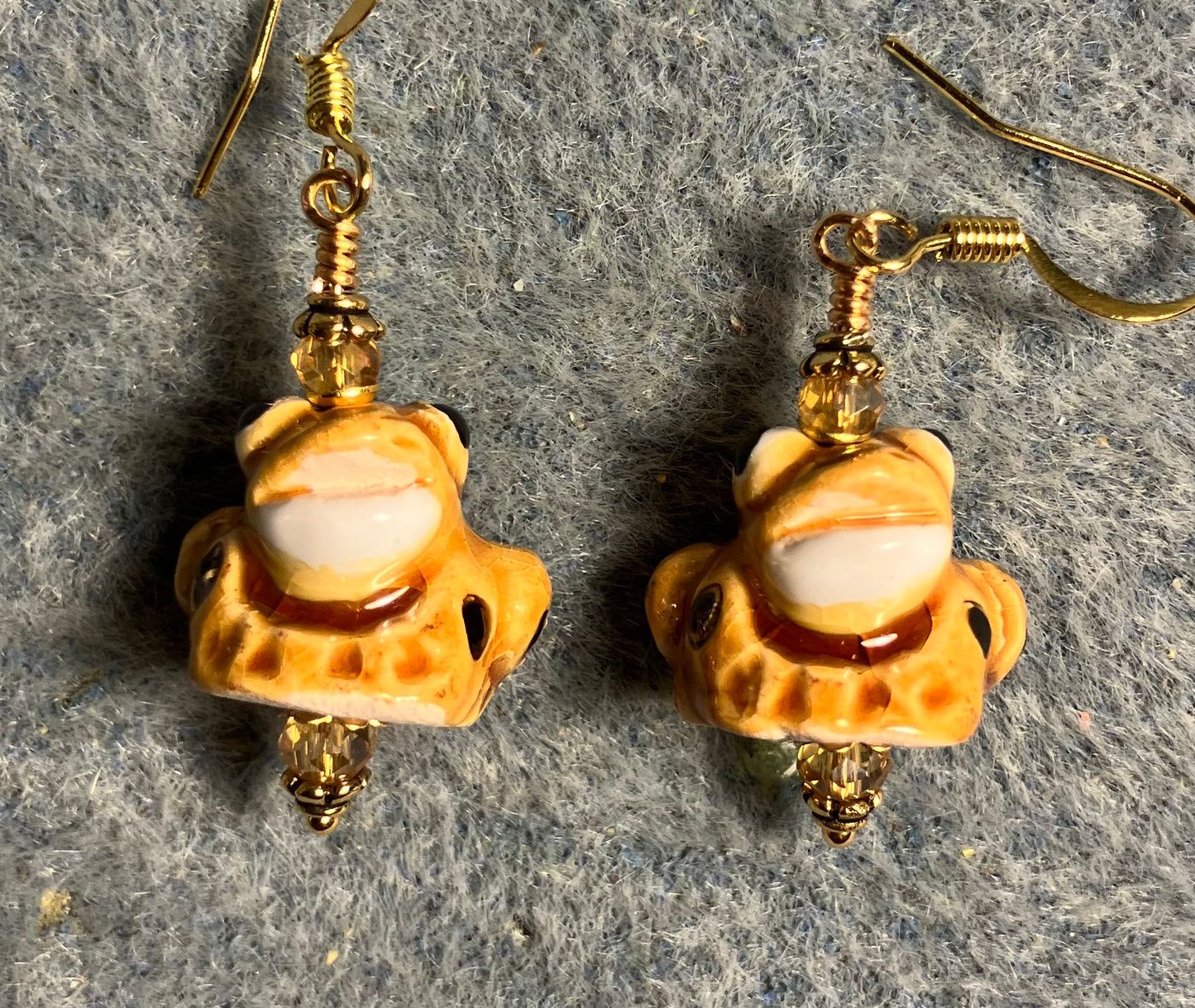 Small amber and black ceramic spotted frog bead earrings adorned with amber Chinese crystal beads.