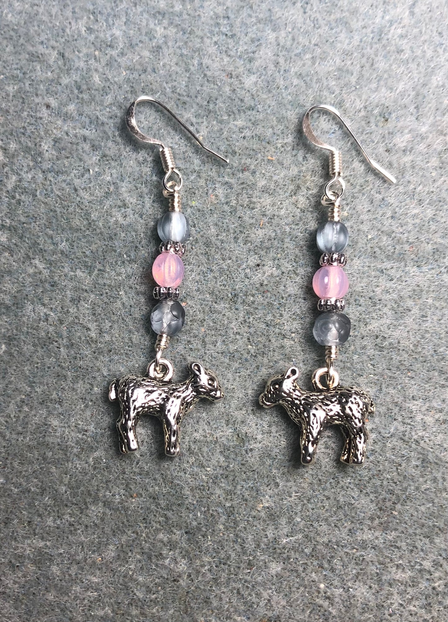 Small silver lamb charm earrings adorned with light blue and pink Czech glass beads.