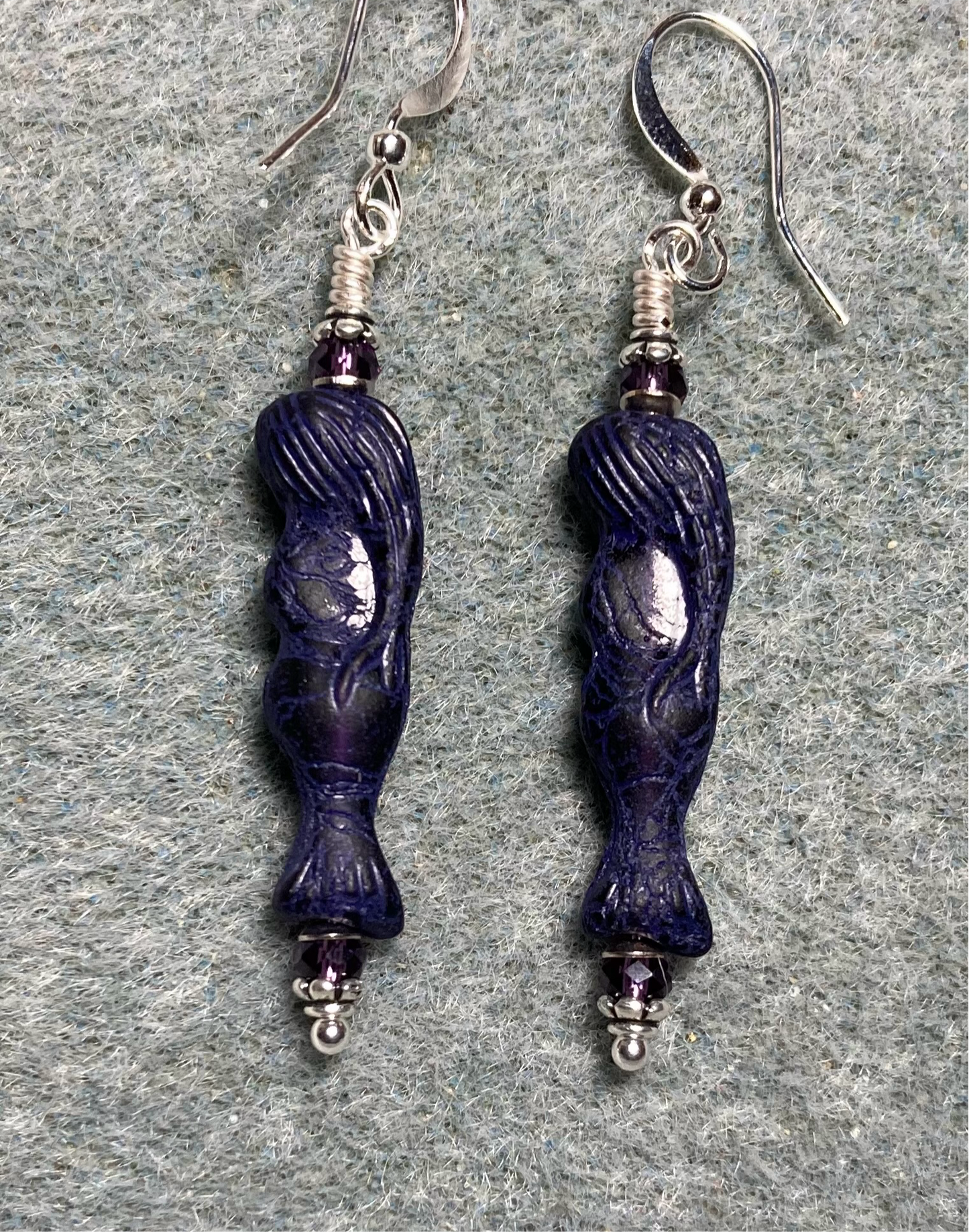 Dark purple Czech glass mermaid bead earrings adorned with purple Chinese crystal beads.