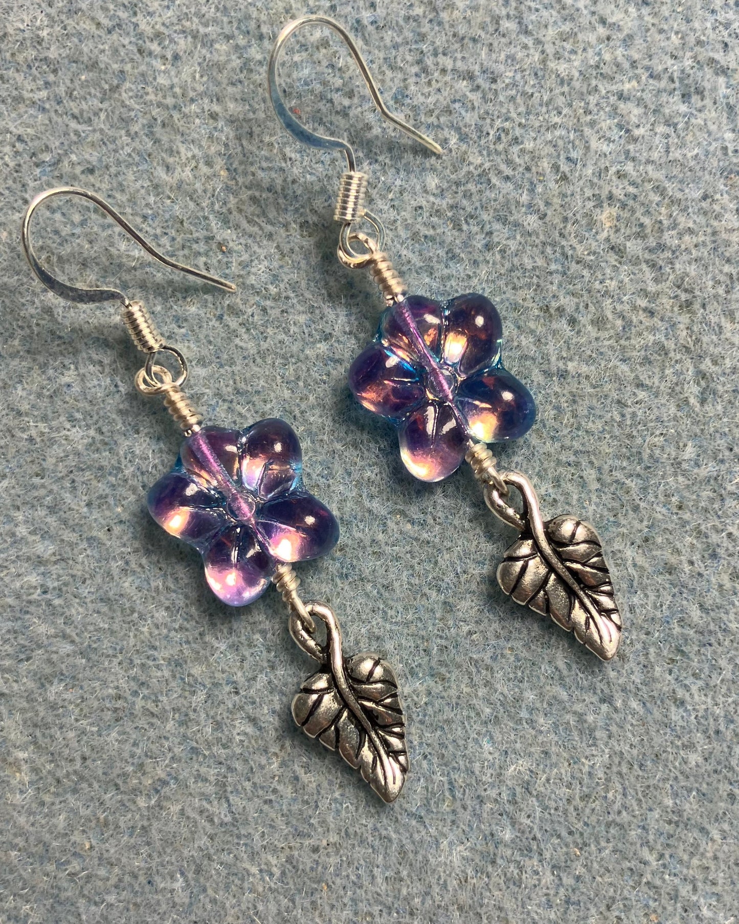 Sparkly purple Czech glass puffy flower bead earrings adorned with silver Tierracast leaf charms.
