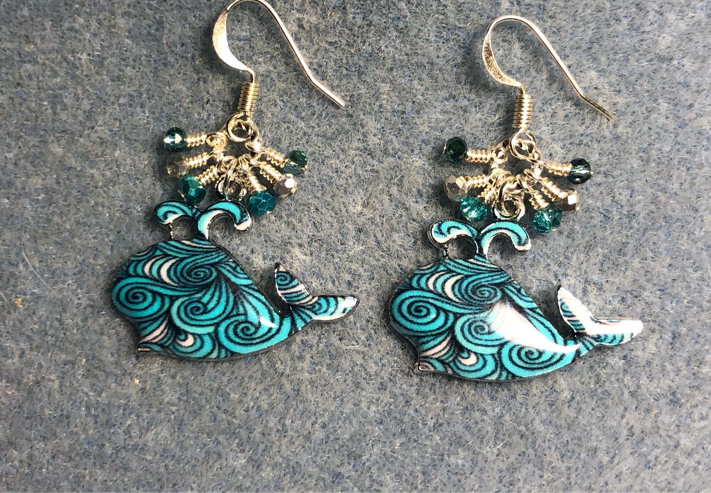 Turquoise patterned enamel whale charm earrings adorned with tiny dangling turquoise and silver Chinese crystal beads.