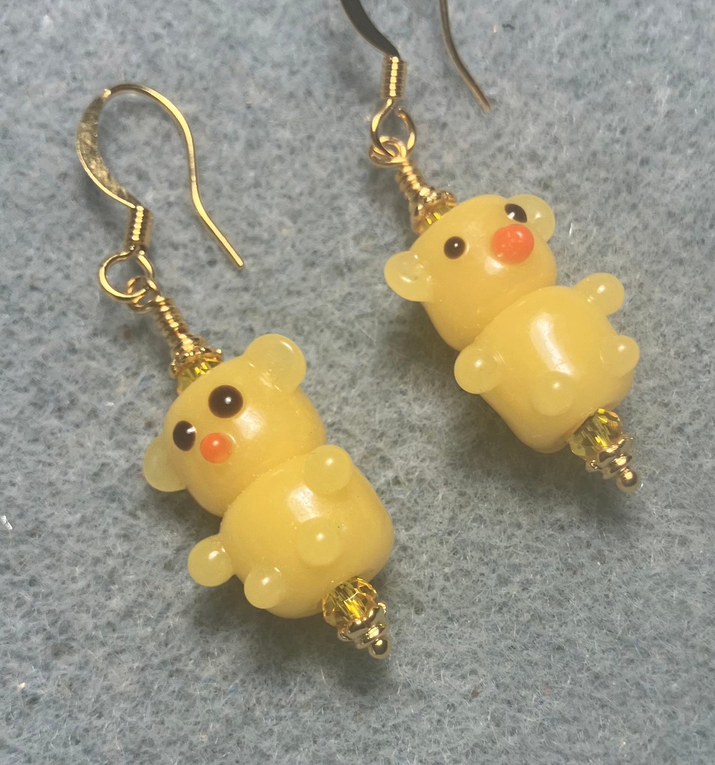 Small amber yellow lamp work teddy bear bead earrings adorned with amber Chinese crystal beads.