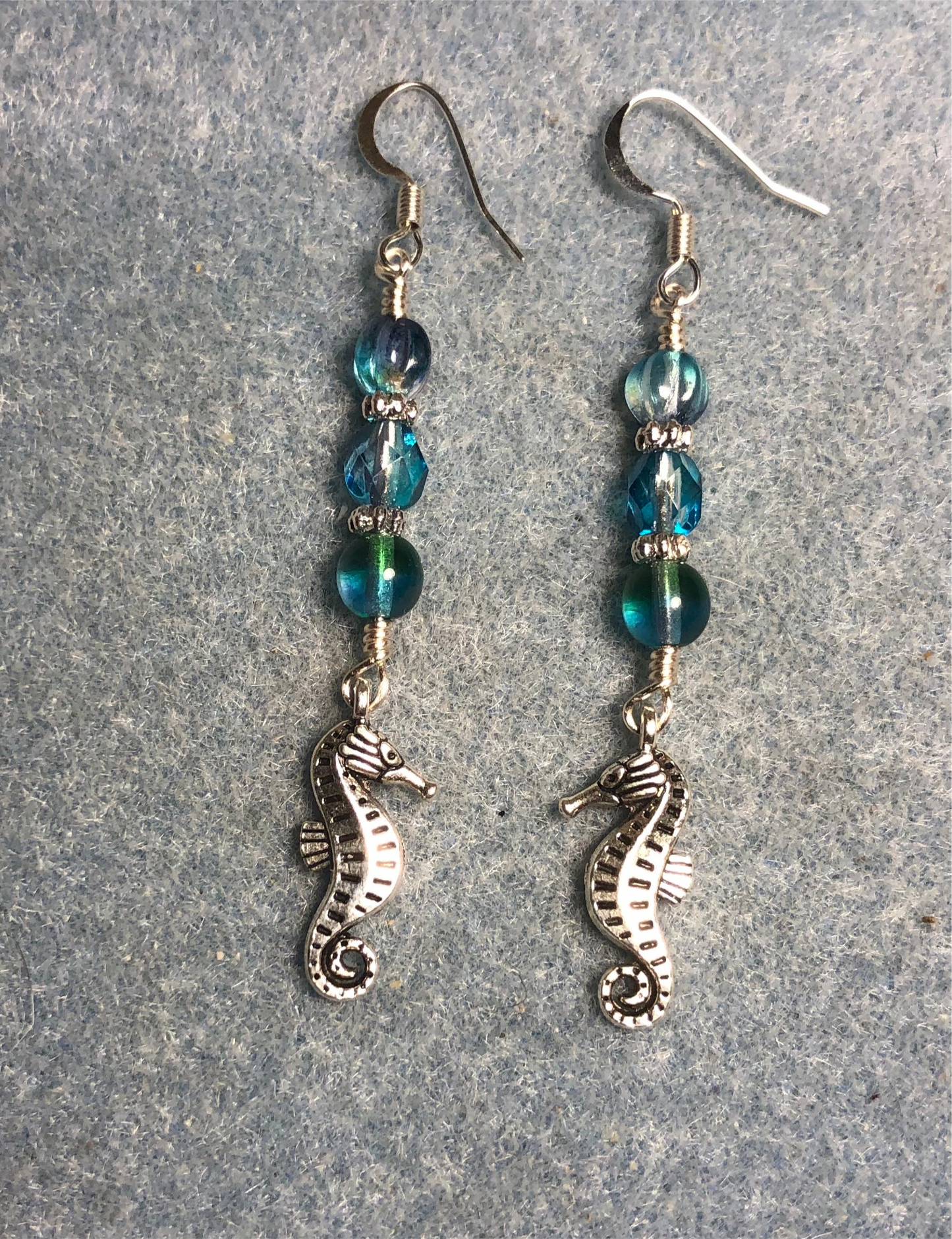 Silver seahorse charm earrings adorned with turquoise purple Czech glass beads