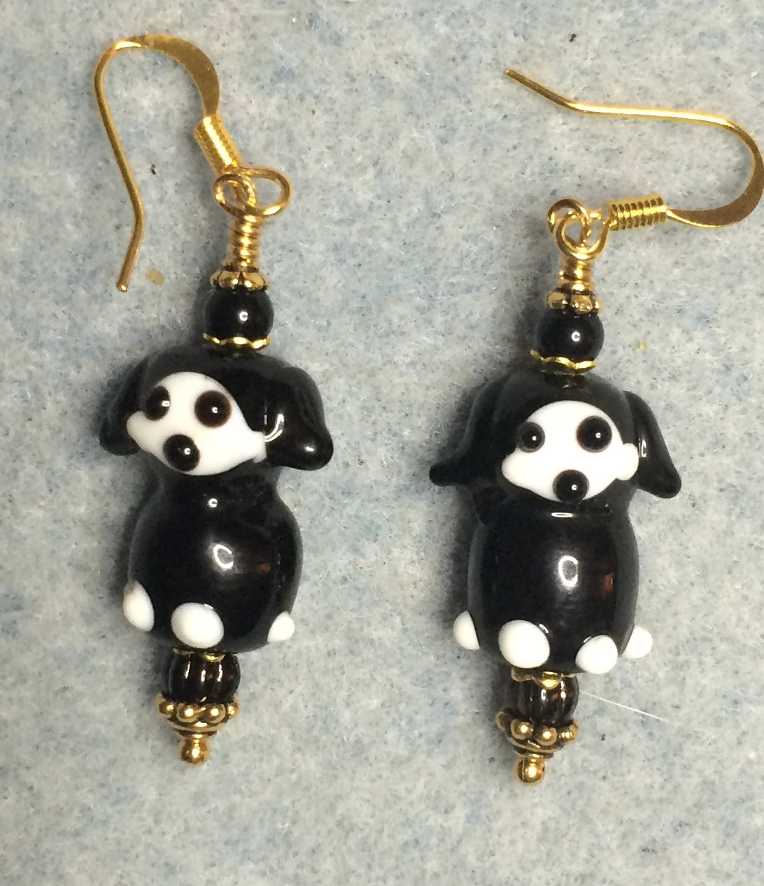 Black and white lamp work puppy dog bead earrings adorned with black Czech glass beads.