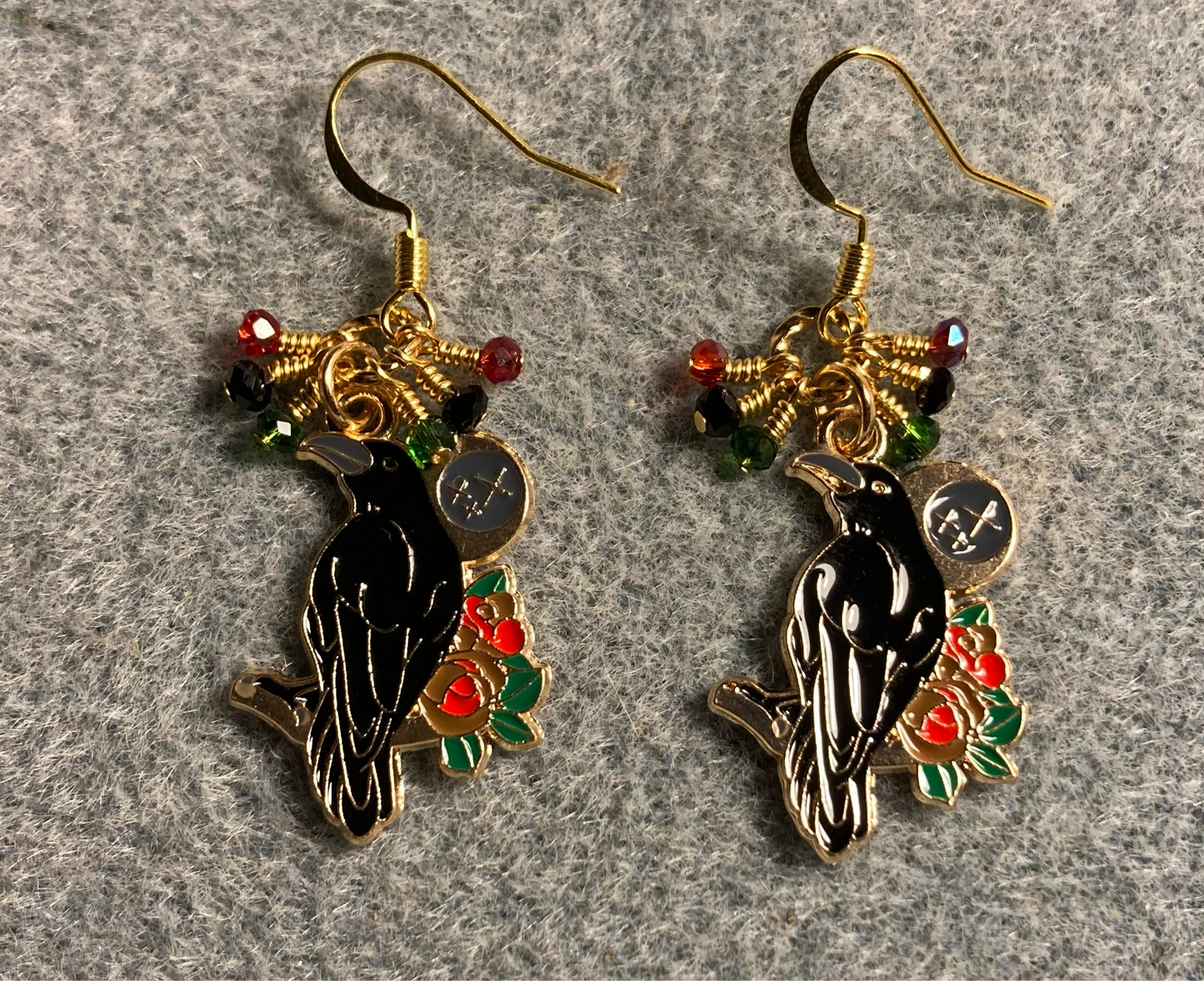 Black, red, and green enamel raven charm earrings adorned with tiny dangling black, red, and green Chinese crystal beads.