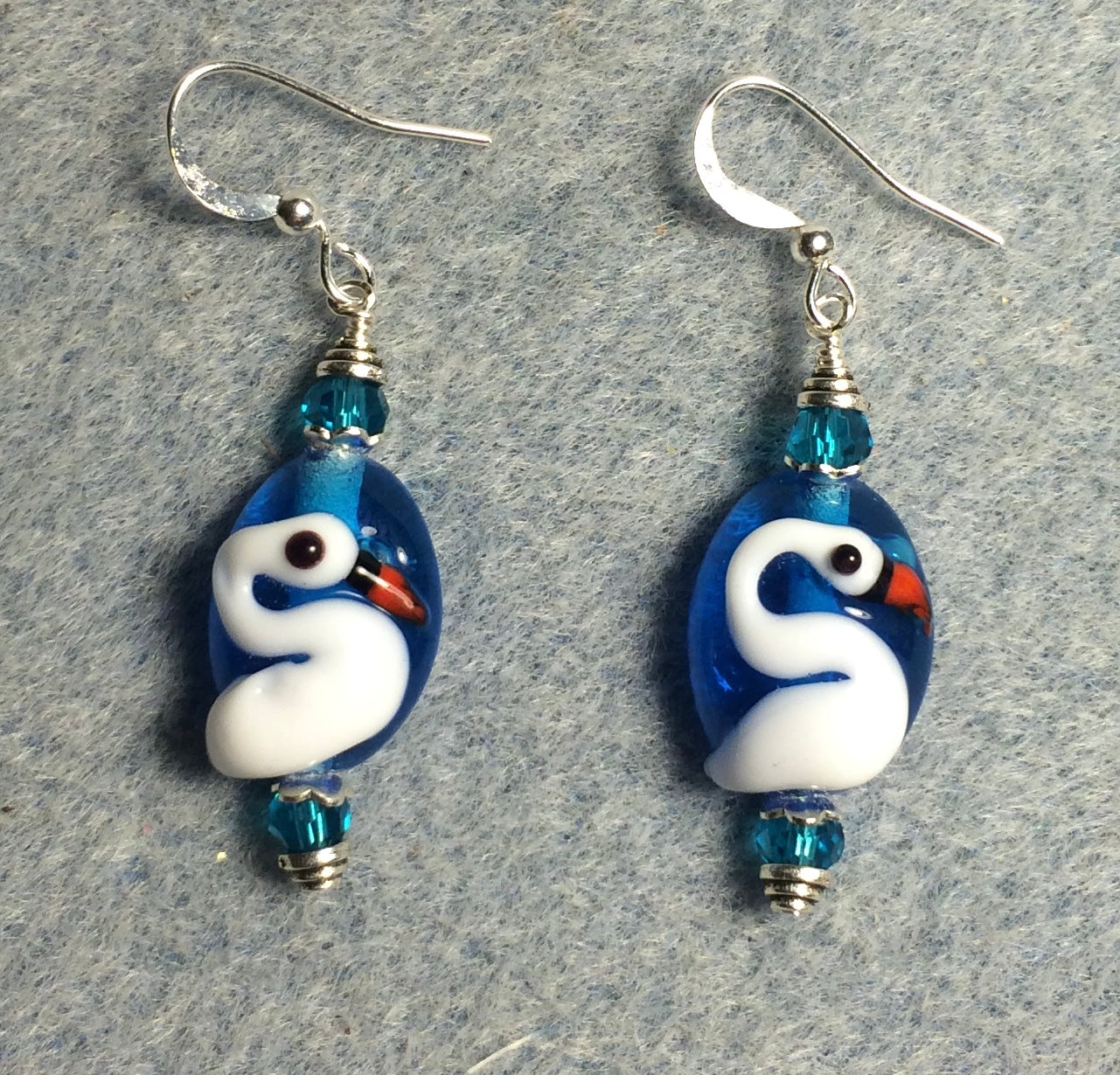Turquoise and white lamp work swan bead earrings adorned with turquoise Chinese crystal beads.