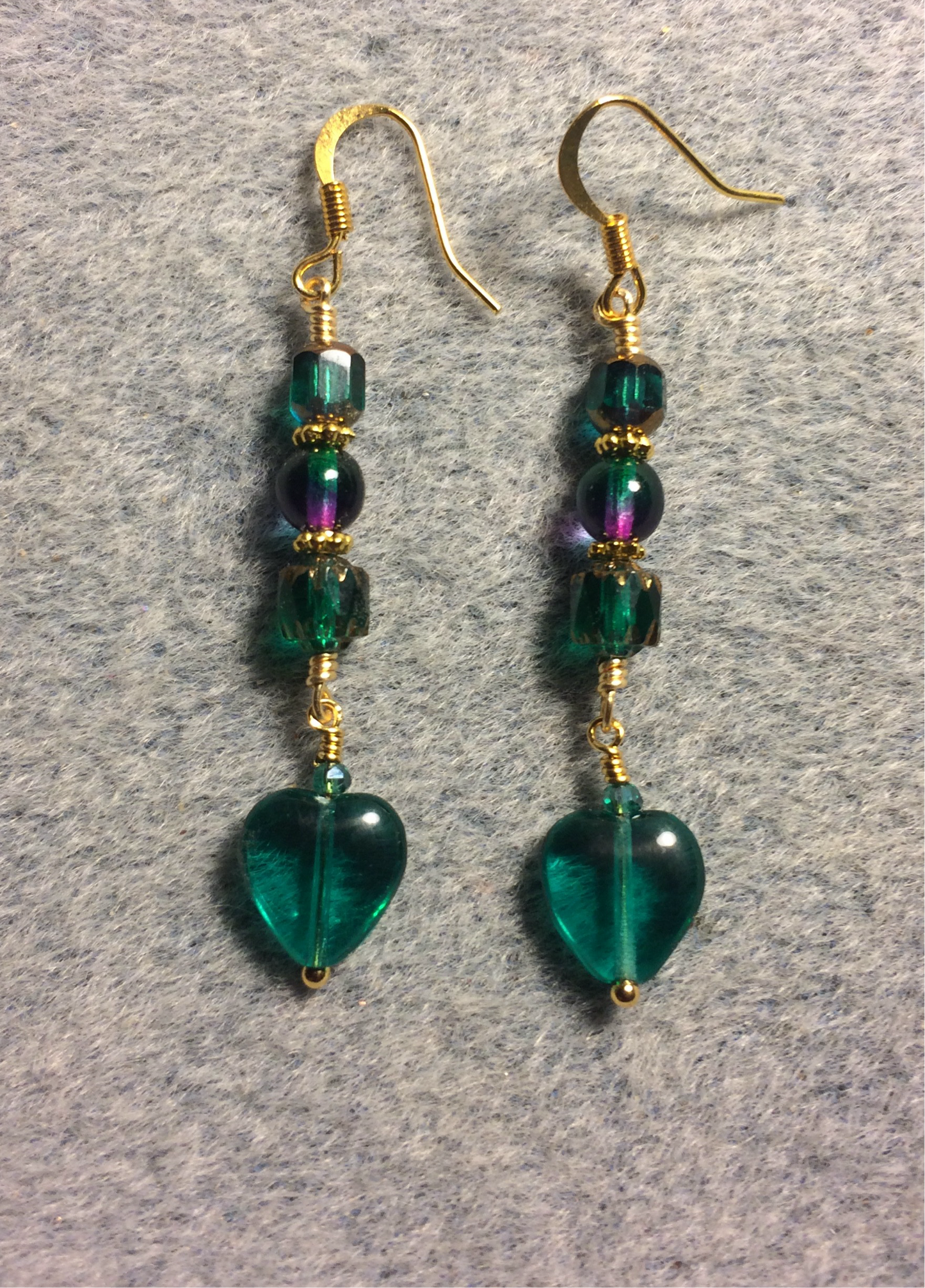 Small teal Czech glass heart bead earrings adorned with teal and teal purple Czech glass beads.