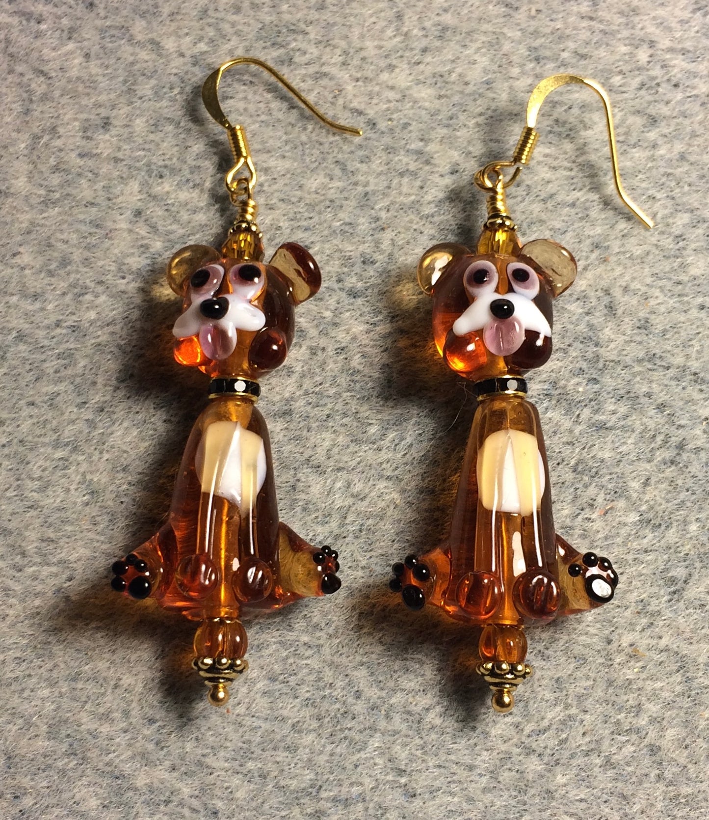 Caramel lamp work dog bead earrings adorned with black rhinestone rondelle “collars” and caramel Czech glass beads.